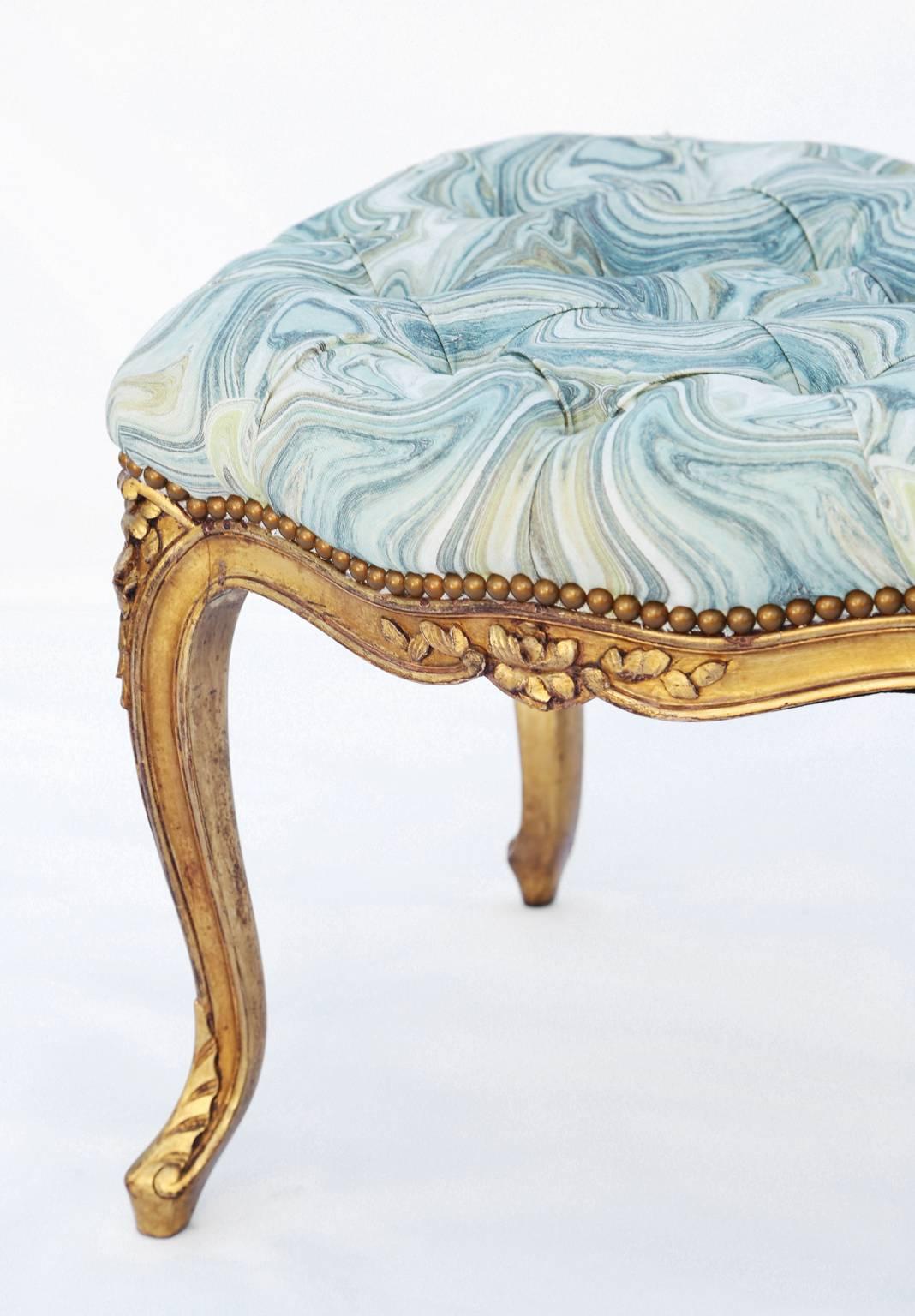 Stool, in the Louis XV style, having a tufted rectangular seat, upholstered, on fielded frame, carved with florals, serpentine apron, raised on foliate-carved cabriole legs, ending in scroll feet.

Stock id: D5821.