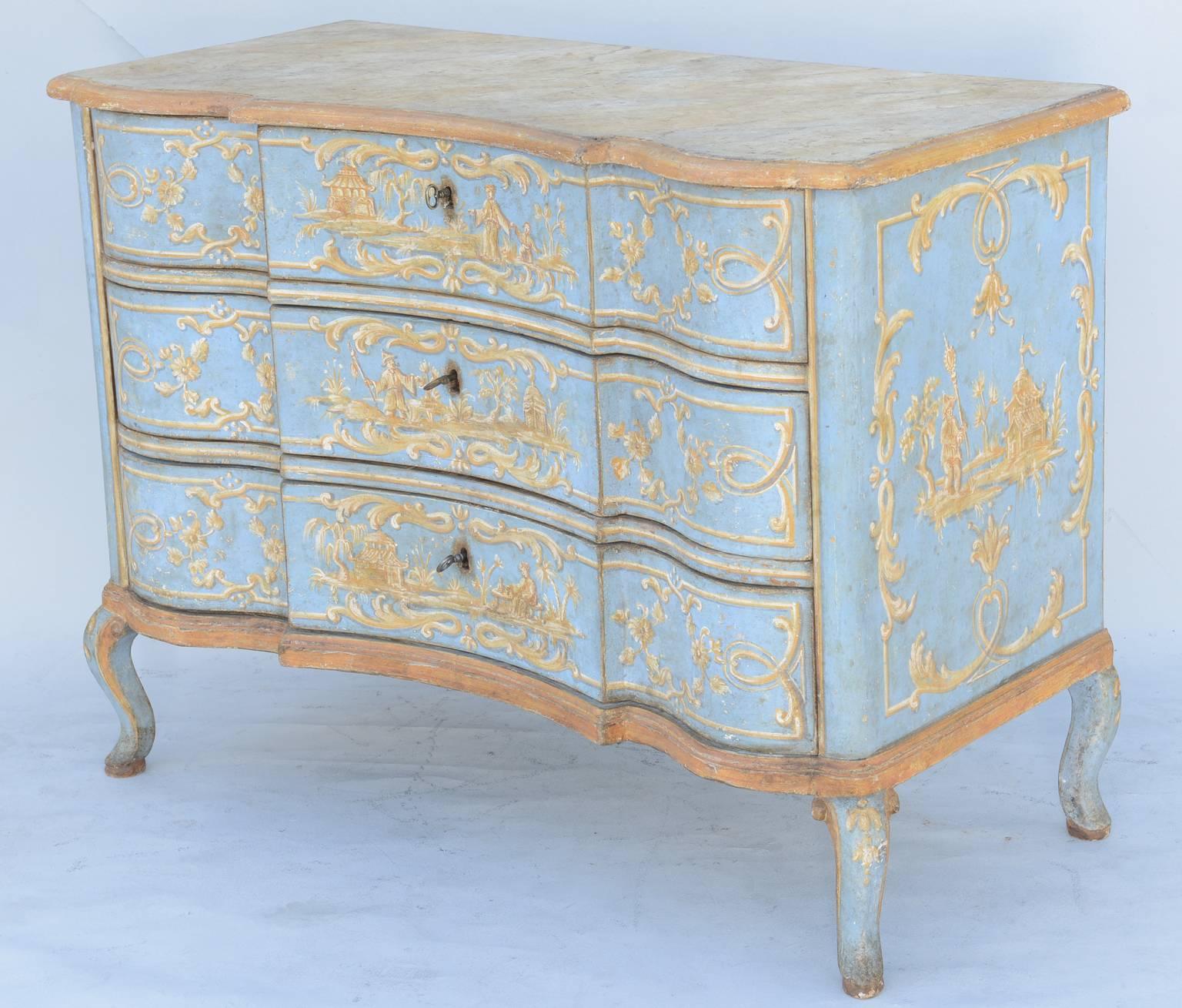 Exceptional Venetian commode, having a faux painted, serpentine molded top, on conforming case, with three stack-drawers, raised on scroll-headed splayed legs, its entire case with later decoration (early 20th century), hand-painted with chinoiserie