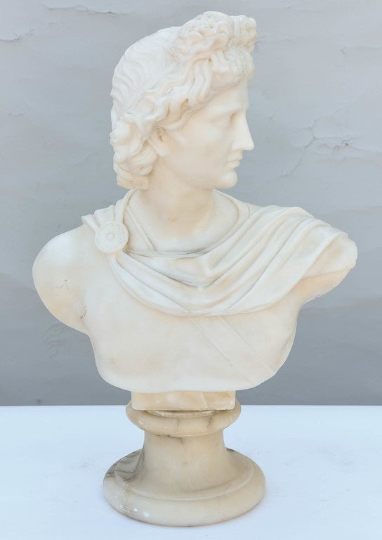 Carved marble bust of Apollo, on round foot of alabaster.