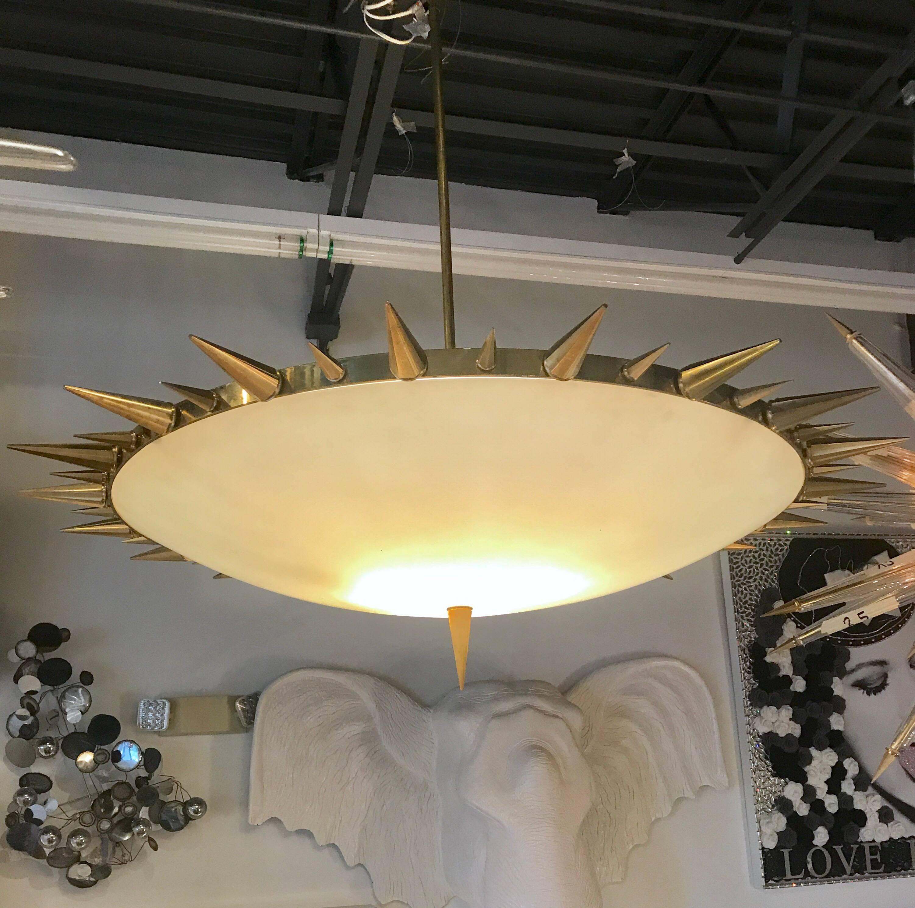 A majestic and unique Italian chandelier of frosted glass with bronze spikes and trim.