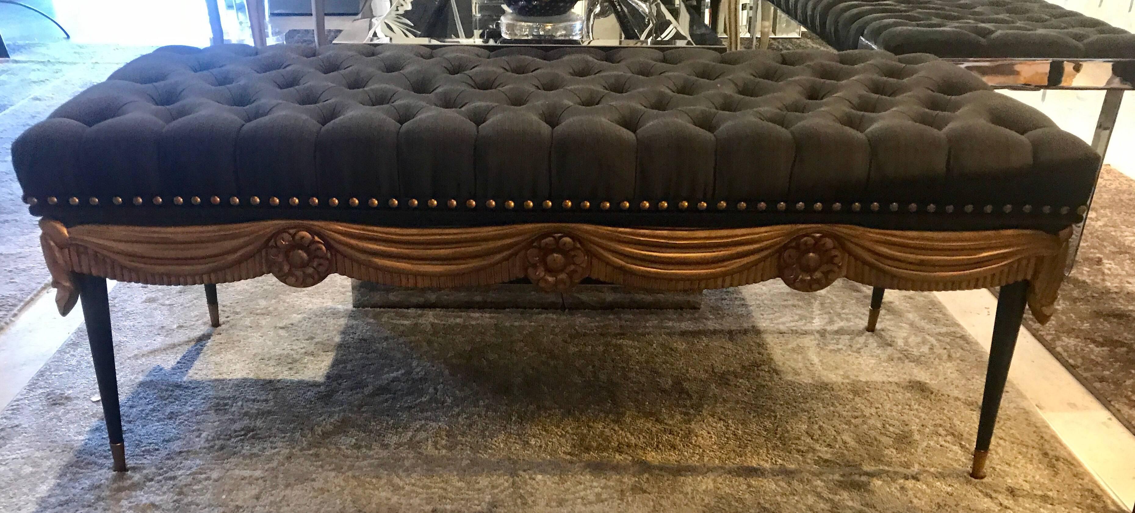 Exquisite pair of midcentury benches of carved and gilded wood, tufted upholstery, and bronze sabots attributed to Maison Jansen.