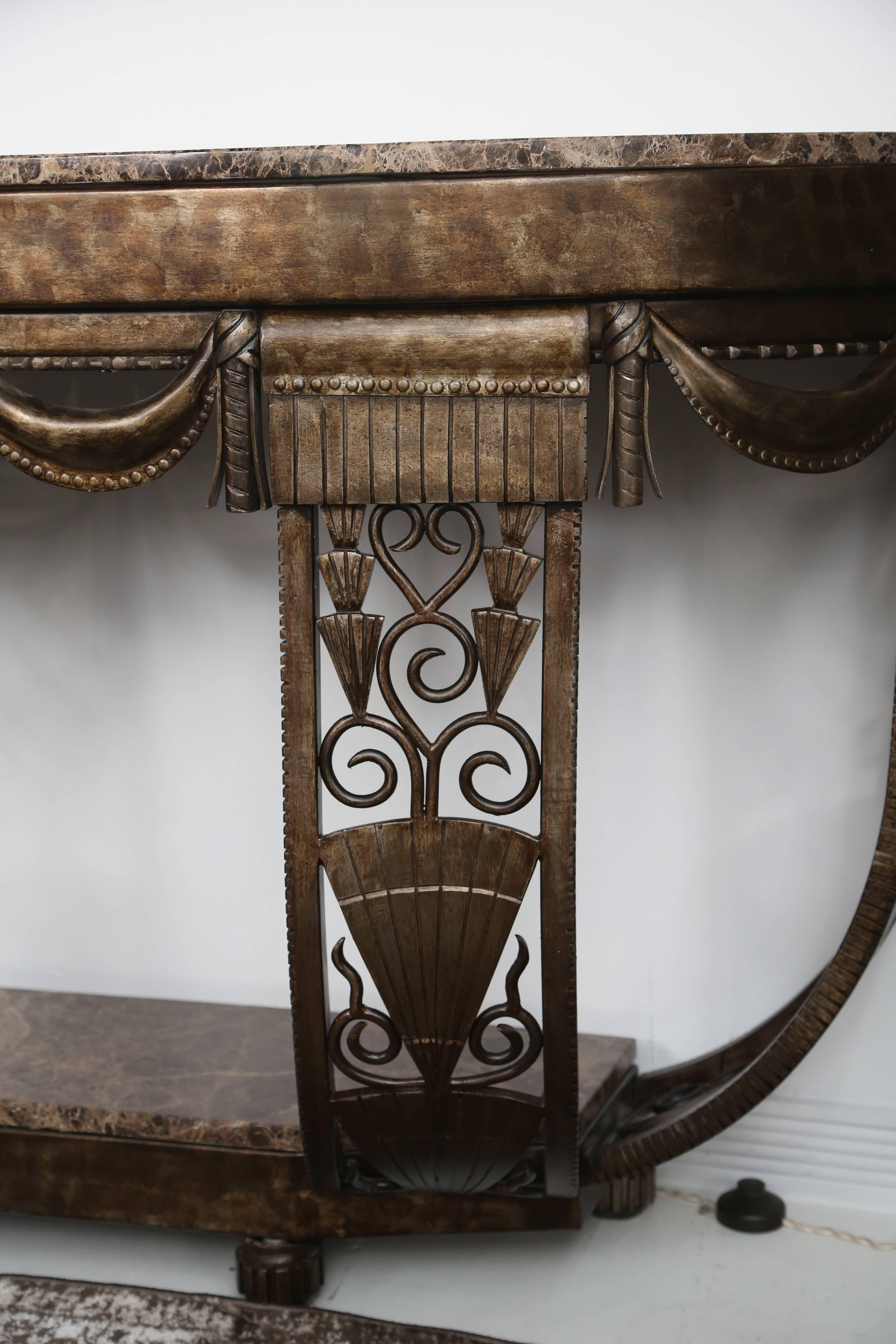 A beautiful hand-forged iron French Art Deco console with marble on the bottom interior and top, in the style and manner of Edgar Brandt.