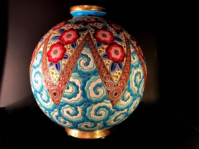 Rare, one of a kind, French Art Deco ceramic and enameled floral vase designed by Maurice Paul Chevallier for Fai¨ences de Longwy decorated in a crackle glaze of vibrant colors and gilt, with a frieze of exotic flowers. The vase is signed