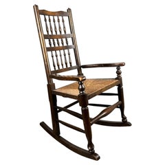 Antique 20th Century Oak Spindle Back Rocking Chair with Rush Seat