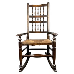 Antique 20th Century Oak Spindle Back Rocking Chair with Rush Seat