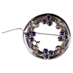 Arts and Crafts Silver Foliate Annular Brooch with Blue Cabochons