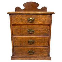 Antique Oak Tabletop Four-Drawer Collector's Cabinet with Shaped Upstand