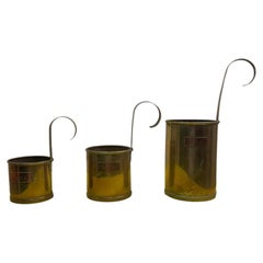 Set of Three British Brass and Copper Hanging Milk Measures, 250ml to 750ml