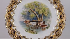 Plato de porcelana de Coalport con diseño reticulado y escena de ganado pintada a mano