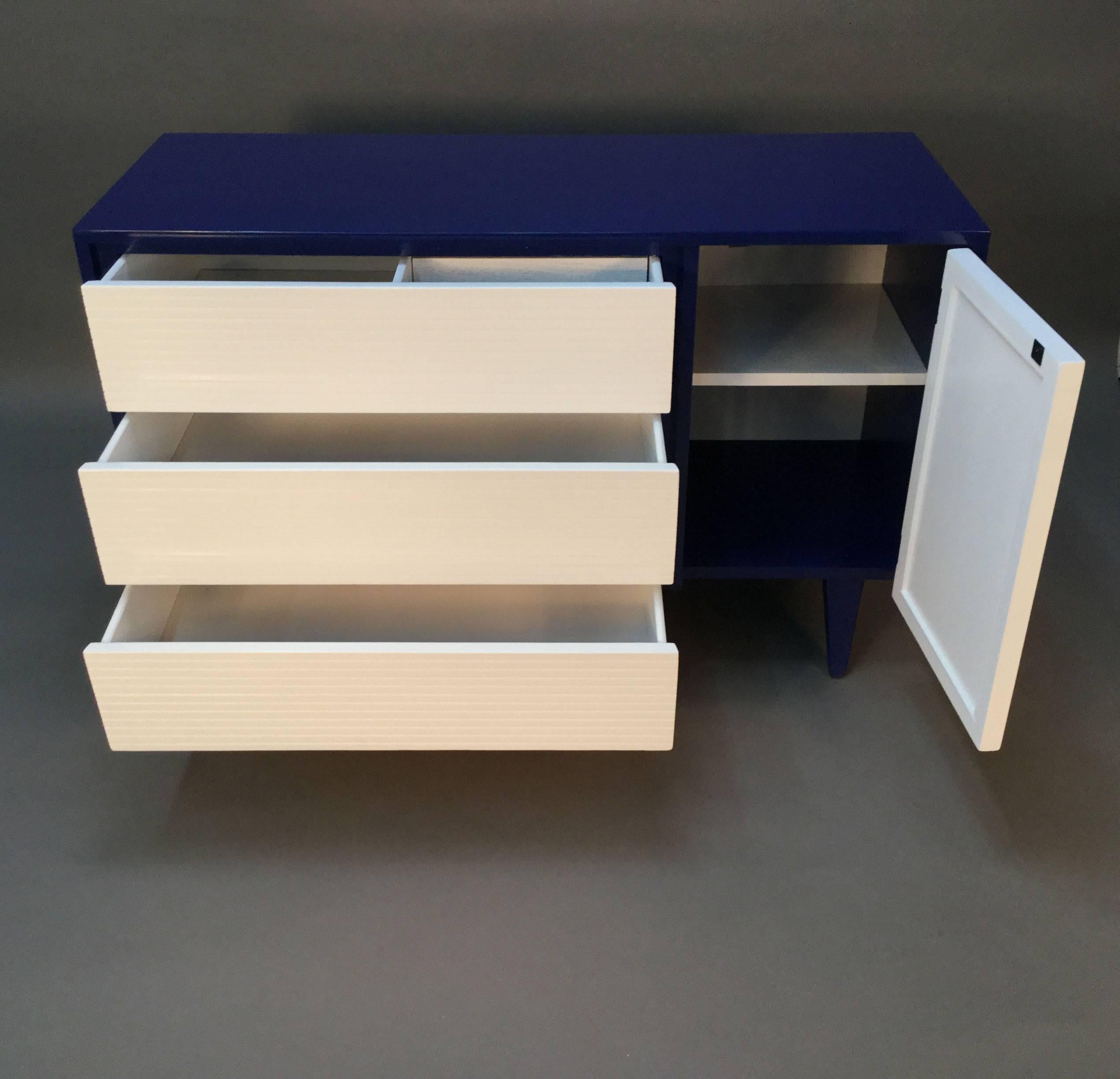 Newly lacquered in two-tone navy and white front. Three-drawer chest with cabinet.
