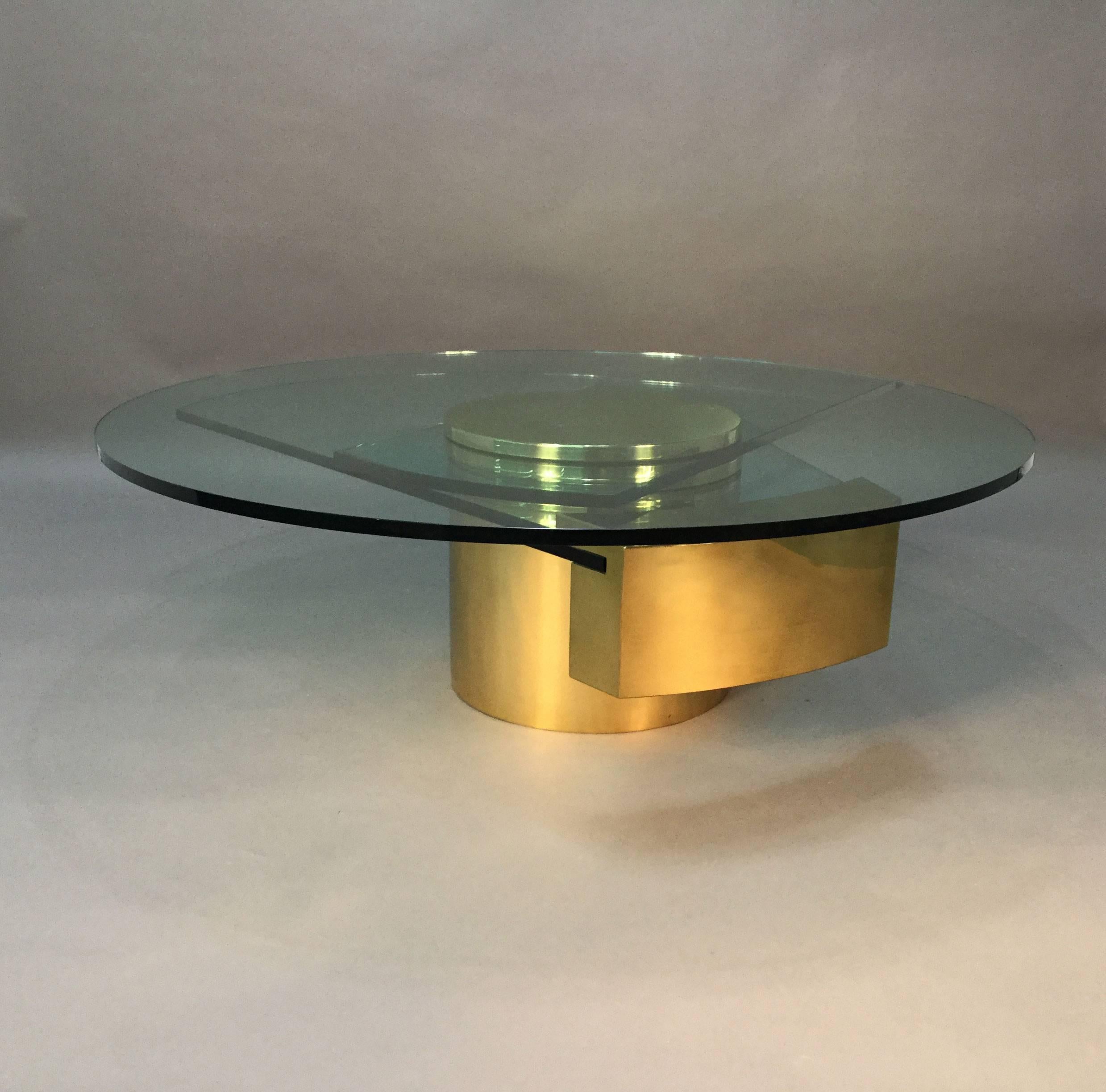 This is an amazing, designed by Dakota Jackson, coffee table. Brass drum base. Three different levels of glass, all rotating. Incredible thick glass plates, with brass frame.