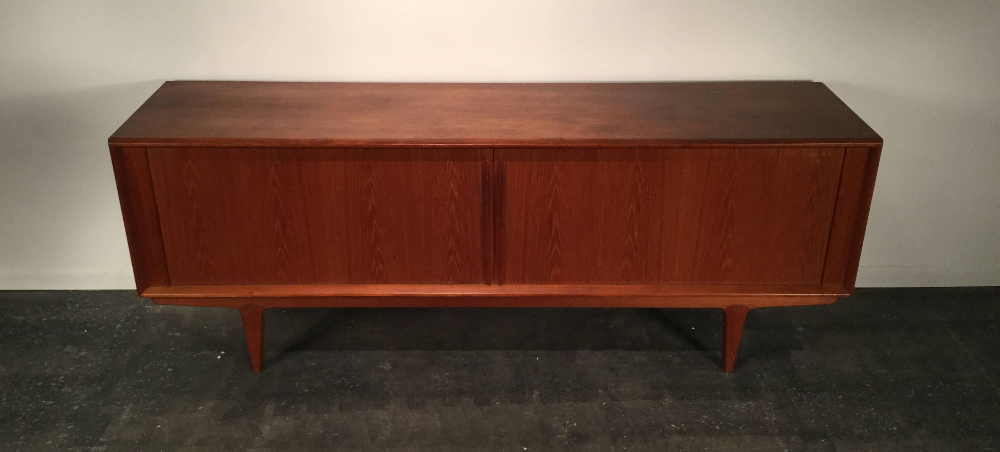 Beautiful teak sideboard with tambour doors, interior shelves and drawers. Danish modern style, nice vintage patina.