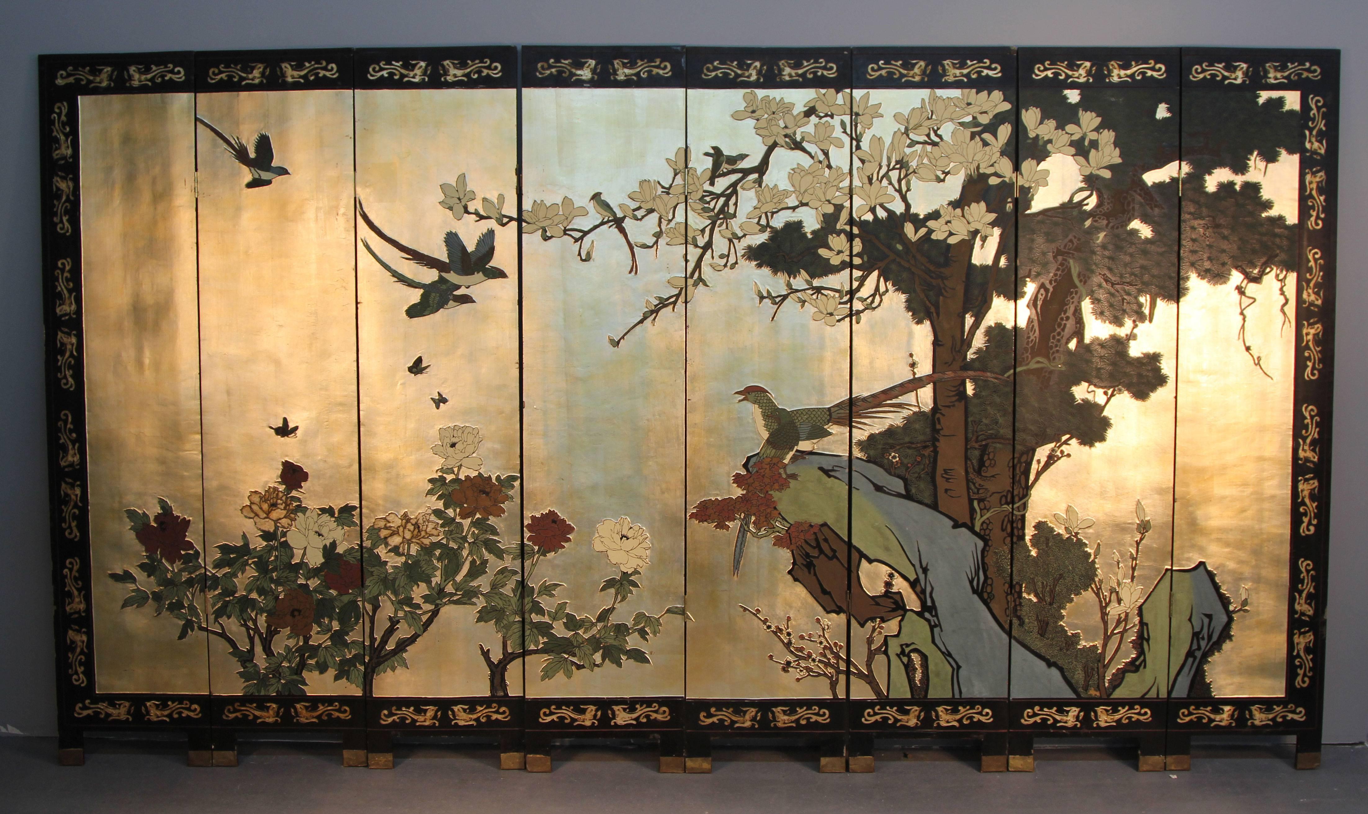 Incredible Asian eight panel screen with brass foot detail.  Gold bird and flower scene on one side and darker black background scene on the other.