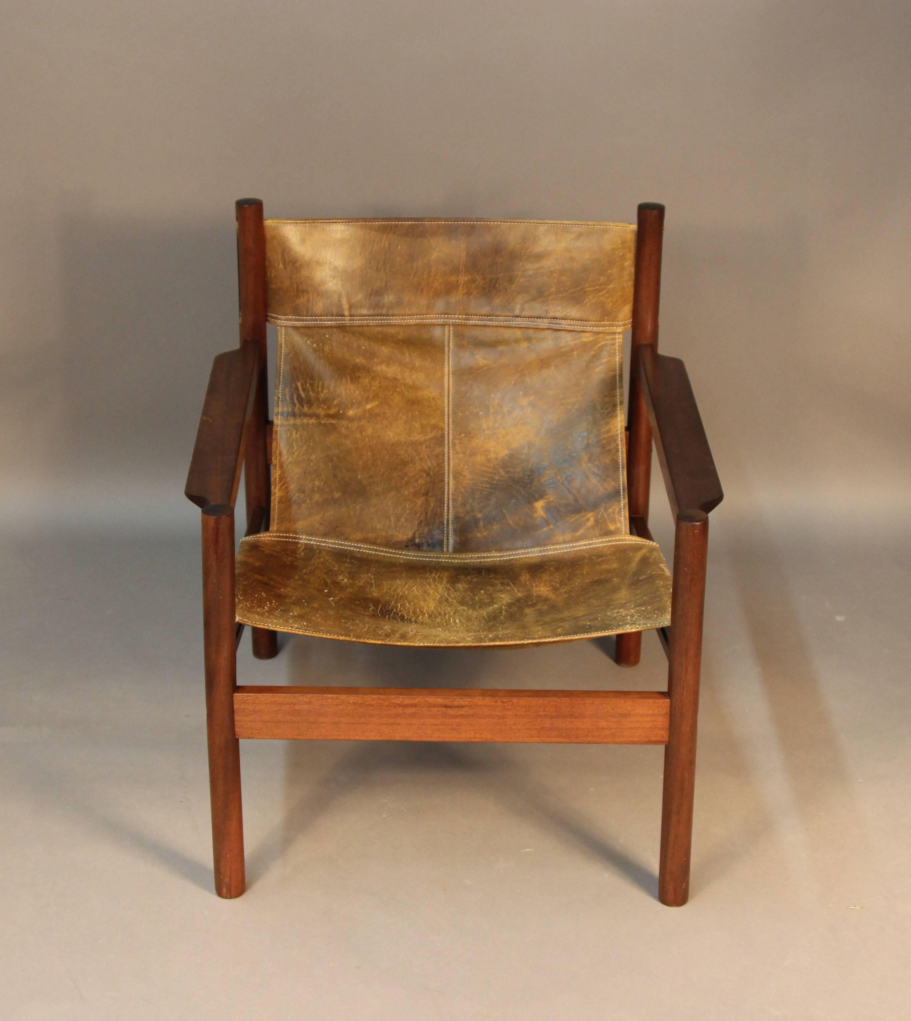 Made in Argentina distressed leather sling back safari chair.