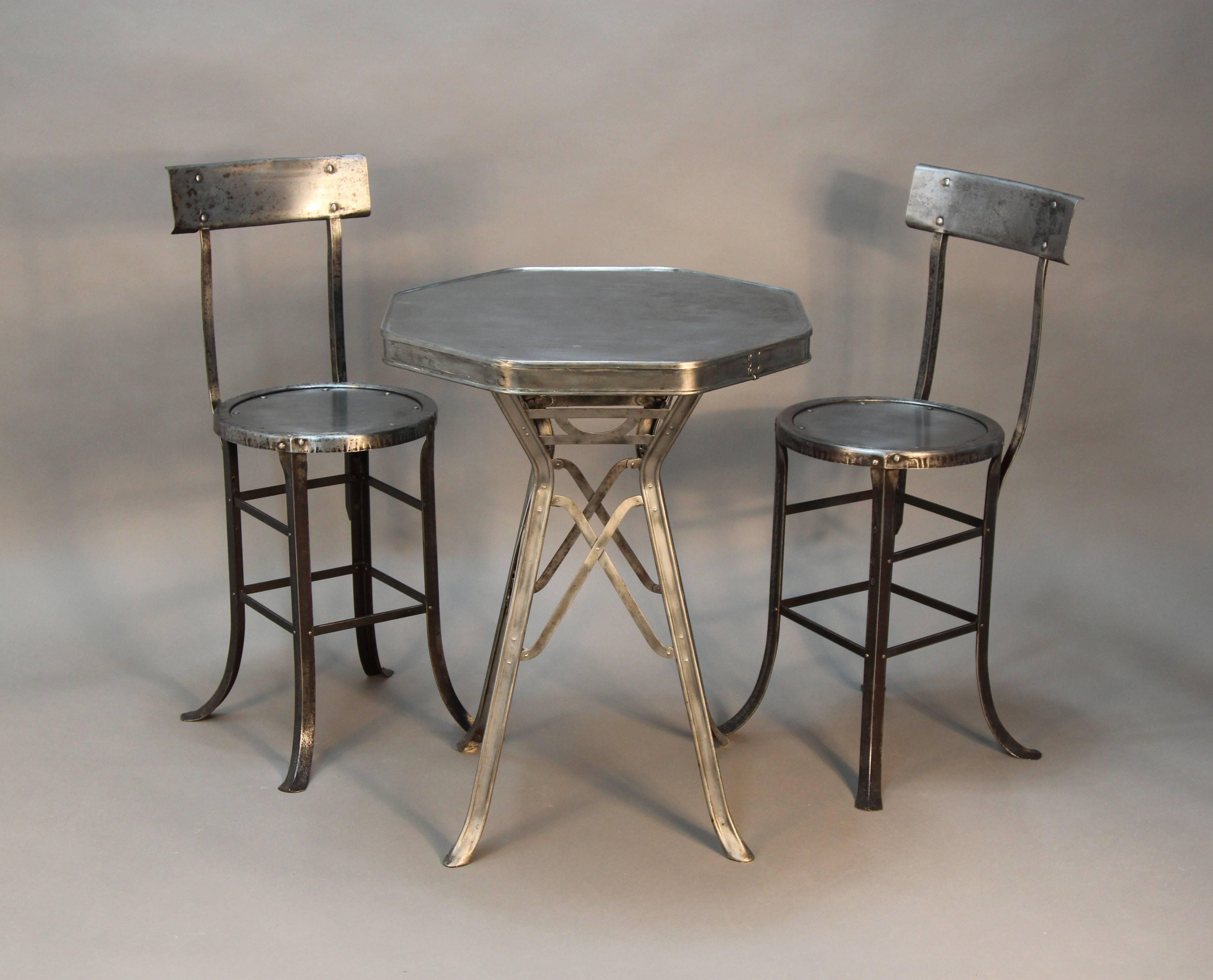Super chic Industrial, octagonal shaped metal table. One of a kind with two matching chairs and excellent detail.