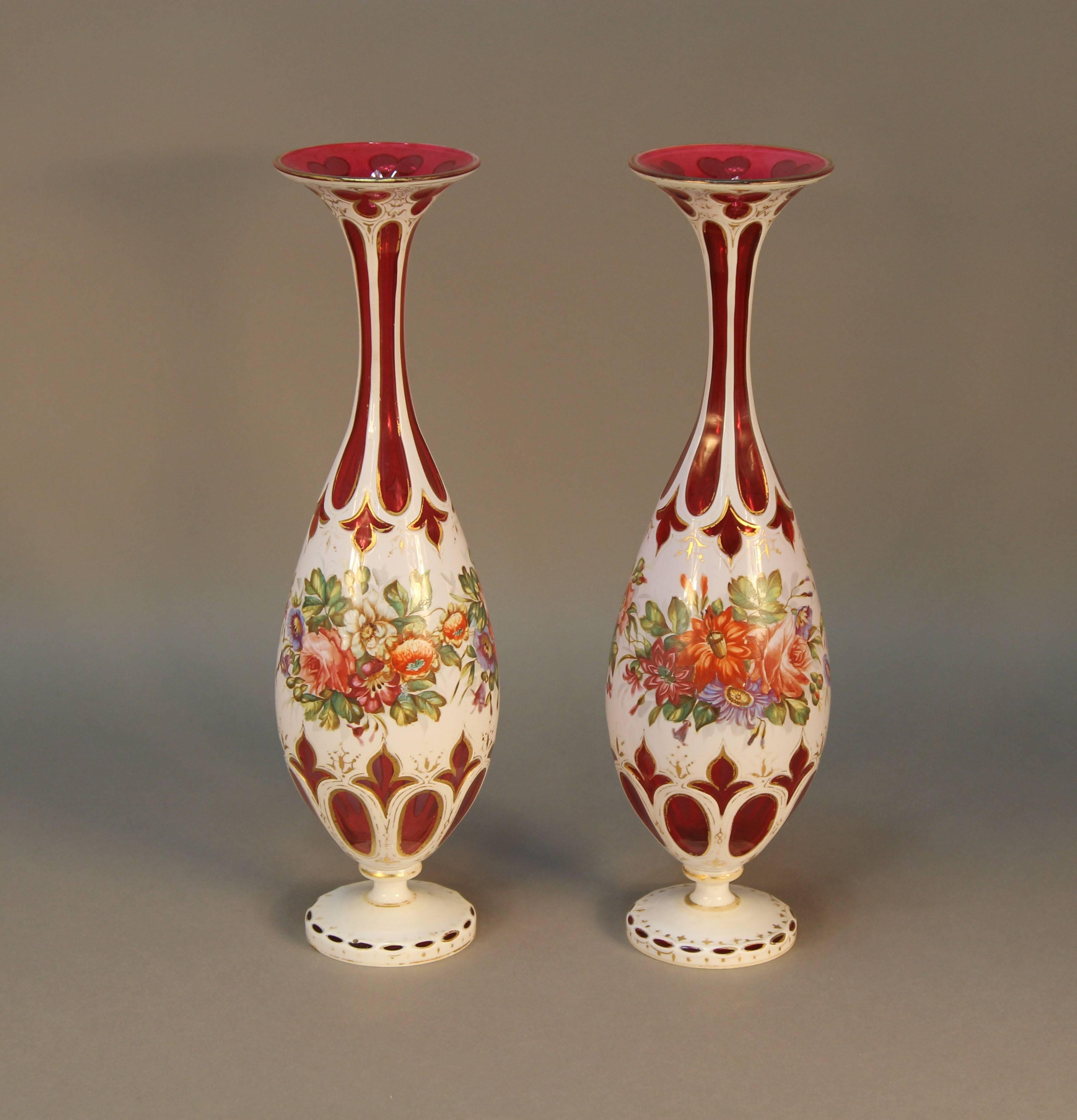 A rare pair of museum quality ruby overlay vases with hand-painted enamel floral decoration.