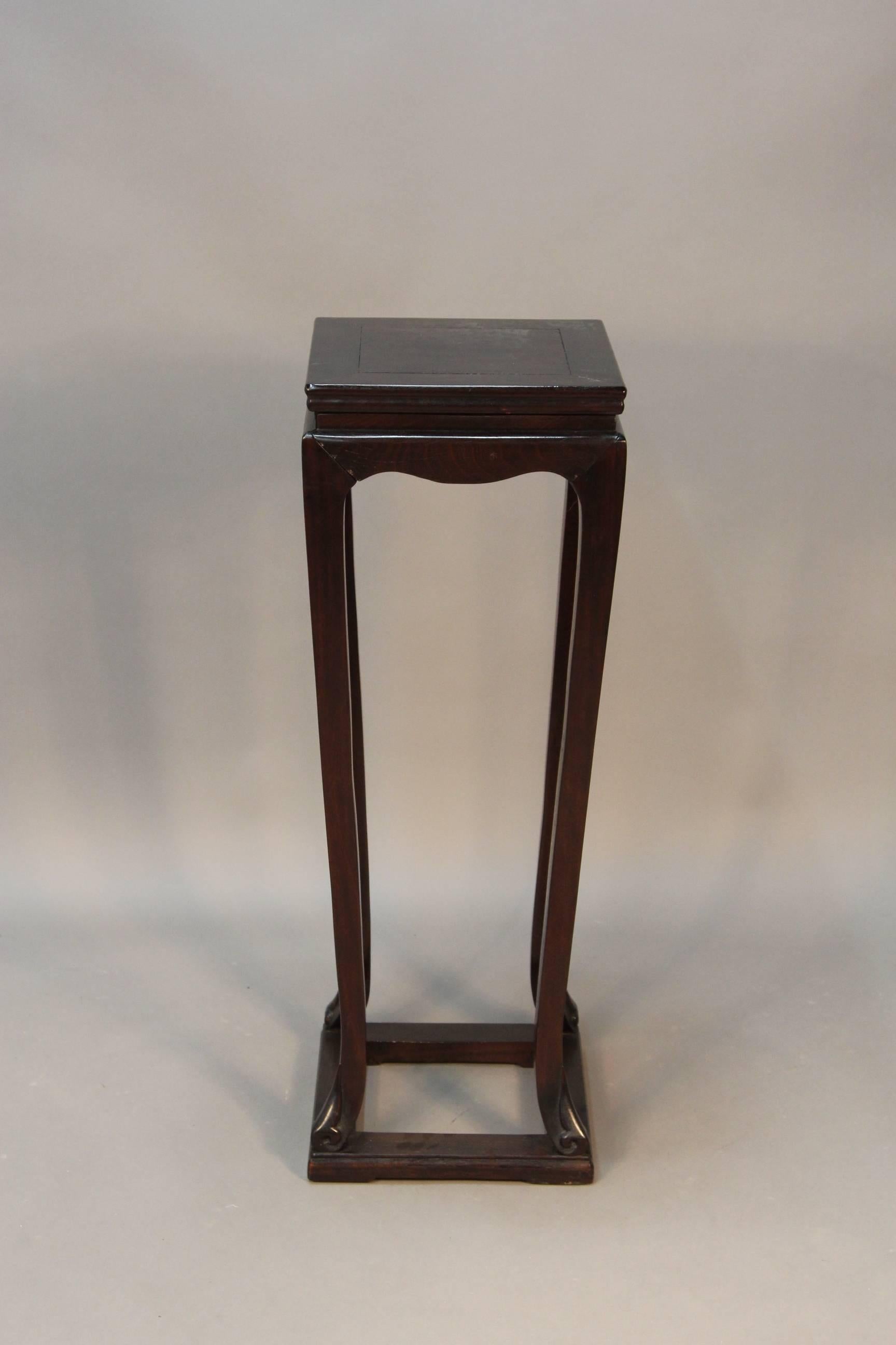 Pair of tall Chinese wood pedestals. These pedestals have a scalloped apron, tapered legs and scroll feet on a box form base, with square shaped tops and hidden drawer in top molding.

Very solid stand with good size tops to accommodate a large