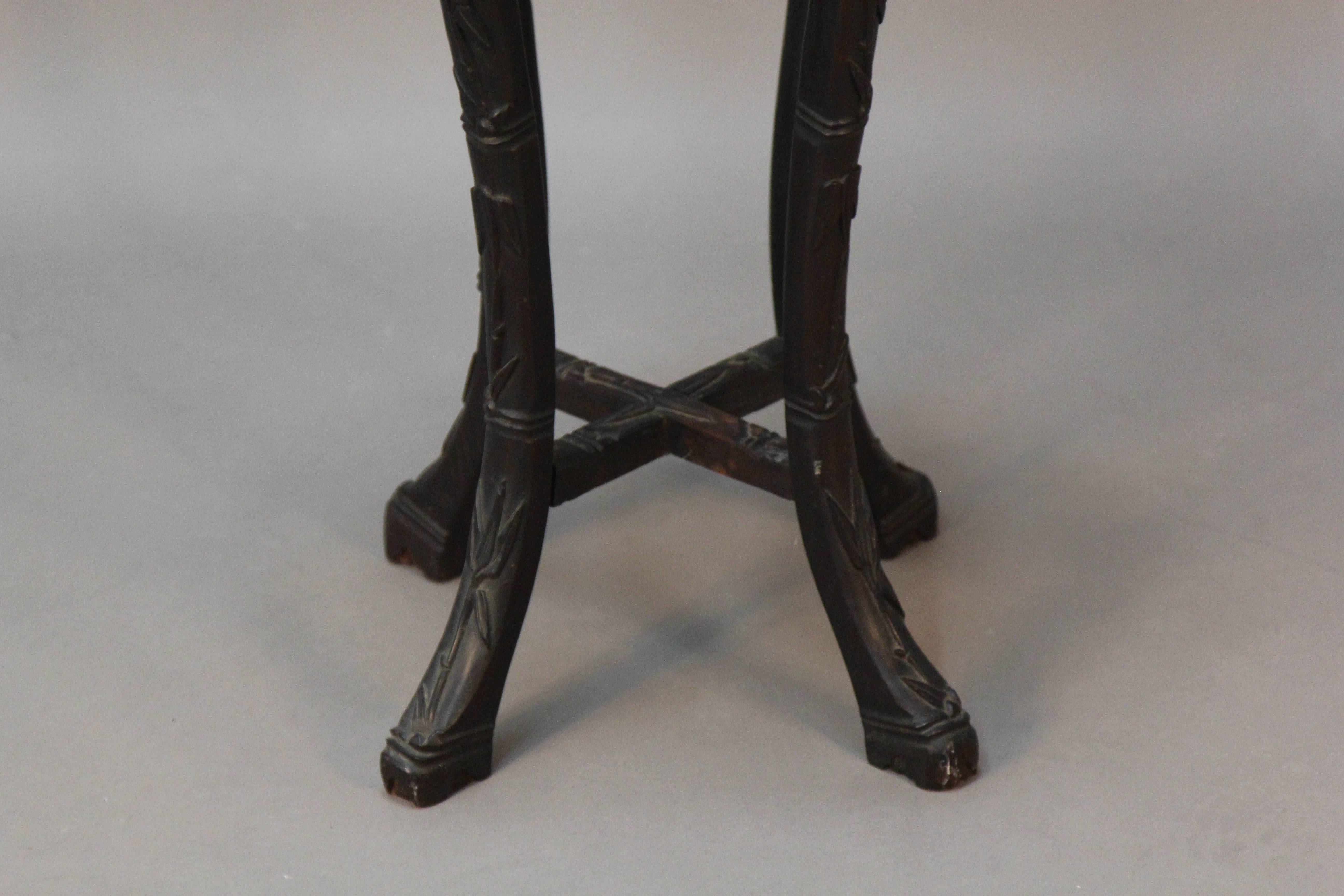 Old hand-carved wood Chinese pot stand in a bamboo design. Entirely constructed with pegs, Chinese writing under marble top. Great patina to wood.
 Nice height for a flower pot or sculpture. Perfect accent piece for any decor.
  