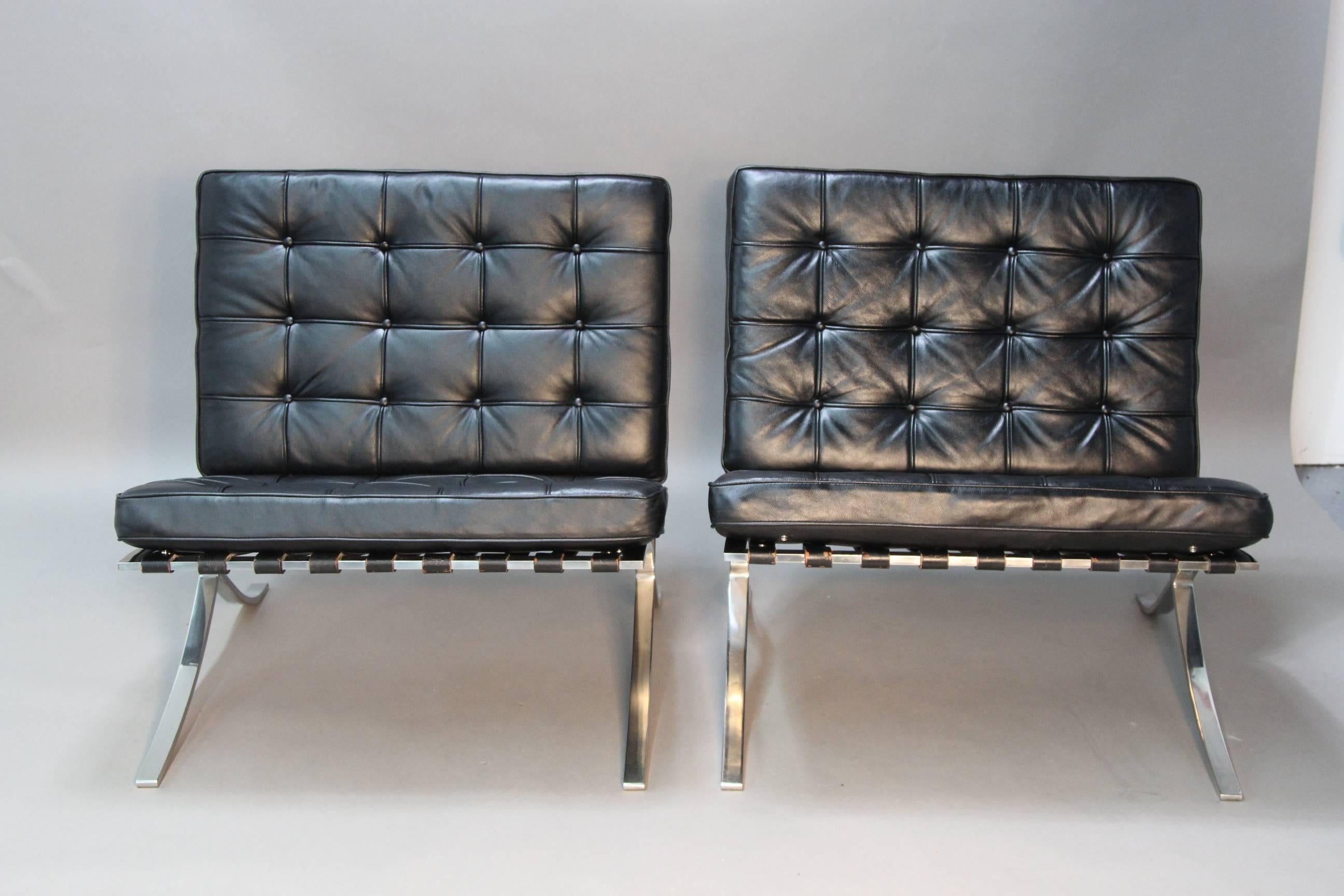 Classic Mies Van Der Rohe Barcelona chairs done in classic black leather. Original frame and straps with new cushions done in Spinneybeck Italian leather used by Knoll.