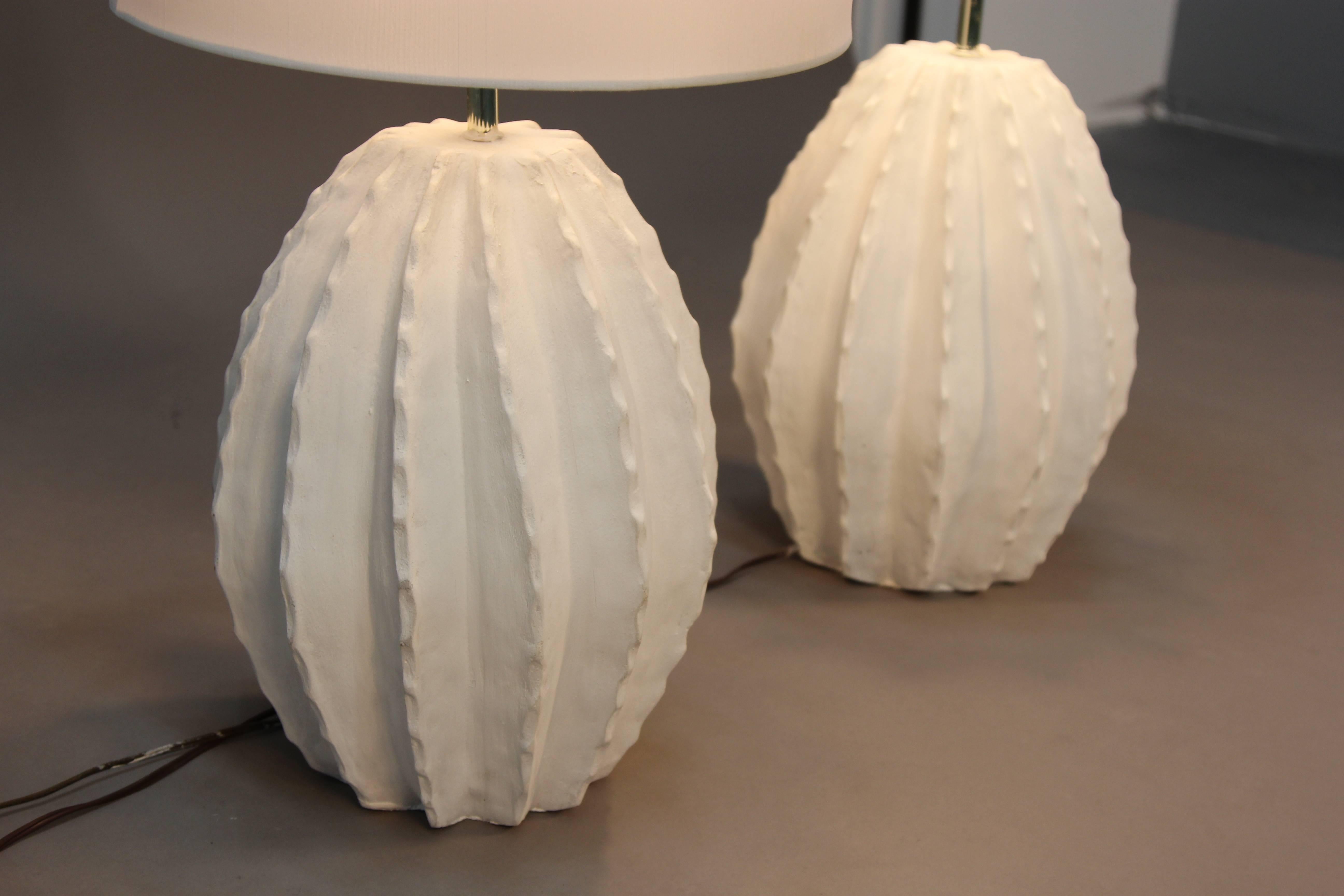 White ceramic cactus shaped table lamps with white lamp shades. Cool and unique vintage style.