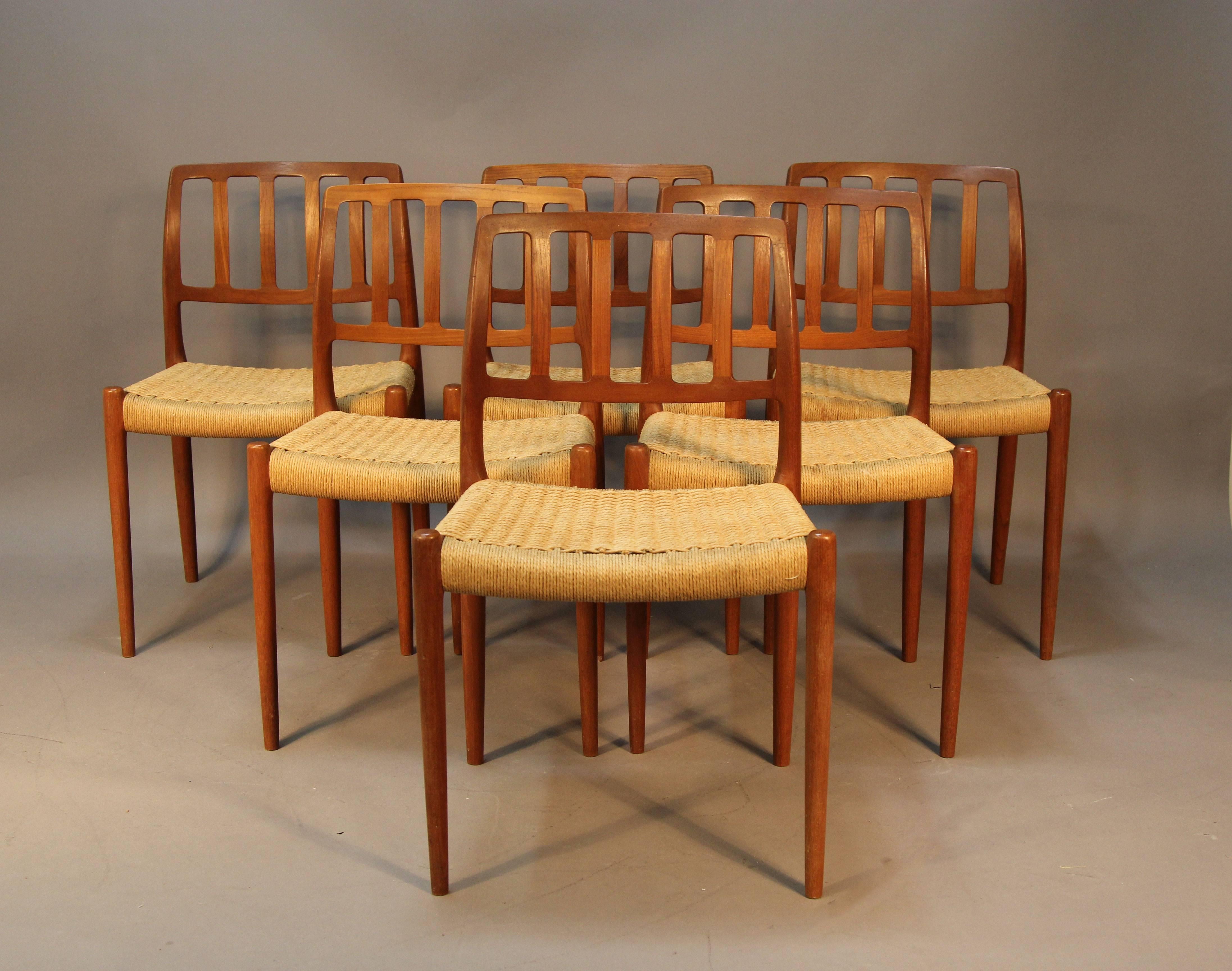 Set of six teak dining chairs with Danish paper chord seats. Stamped under seats. Niels Otto Møller for J. L. Møller. Excellent original condition, some light wear from use. Original, 1960s.