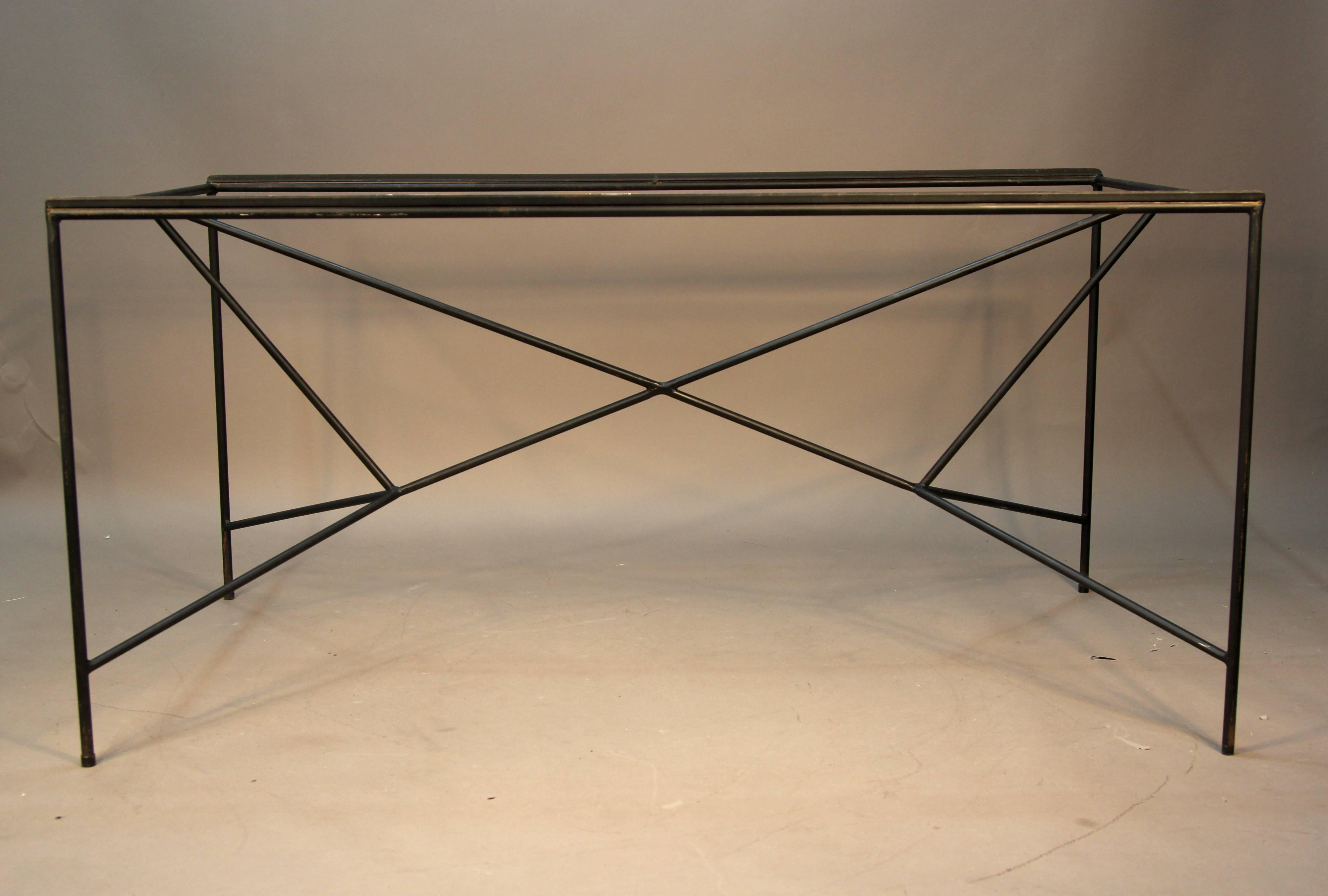 Very rare Paul McCobb iron base dining table or desk. Welded iron triangular shapes make up this linear base with inset glass top.