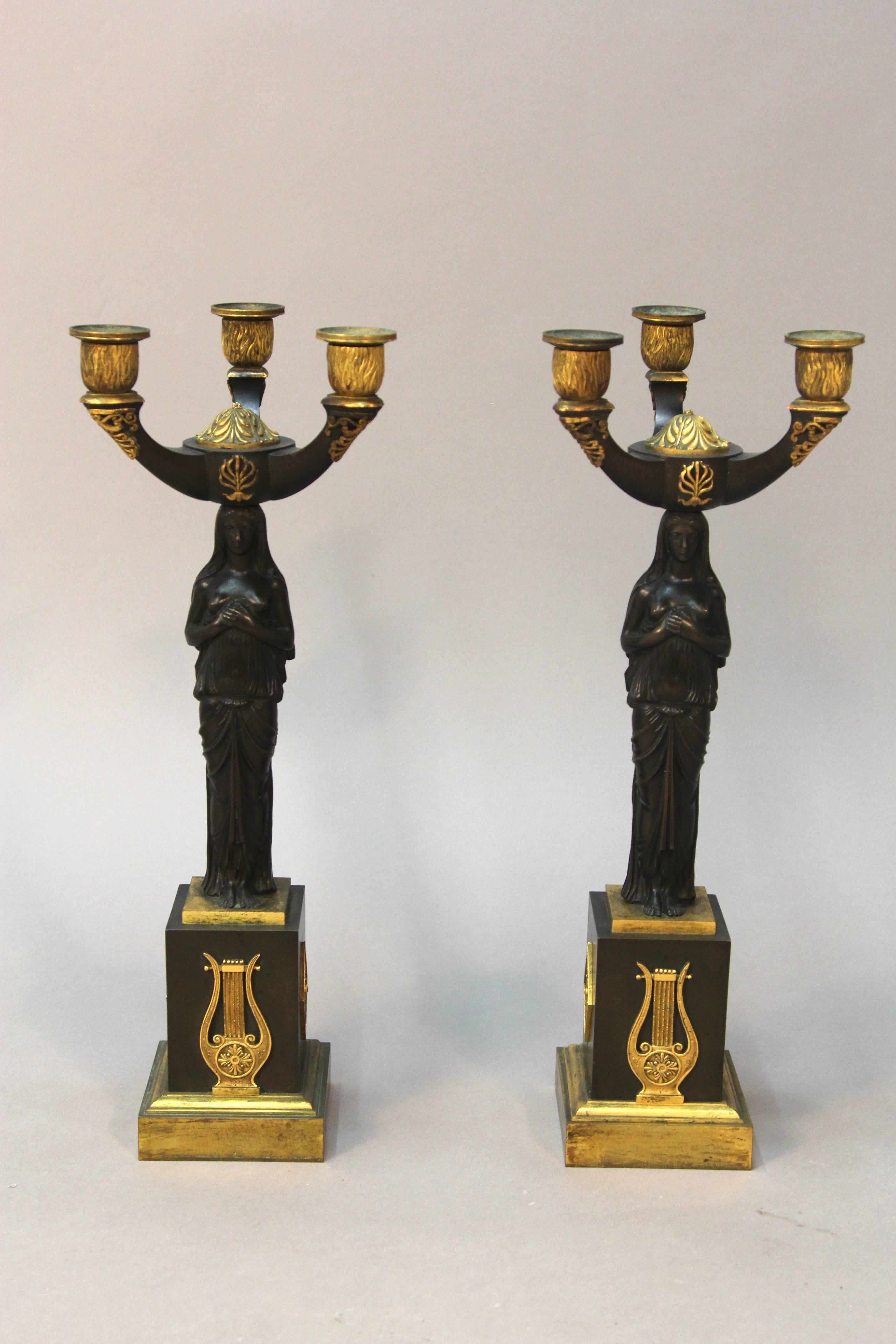 A very fine pair of circa early 1800s Empire gild gold bronze candelabras depicting classical women with breast exposed. Exquisite made, suggesting Russian 19th century manufacturing.