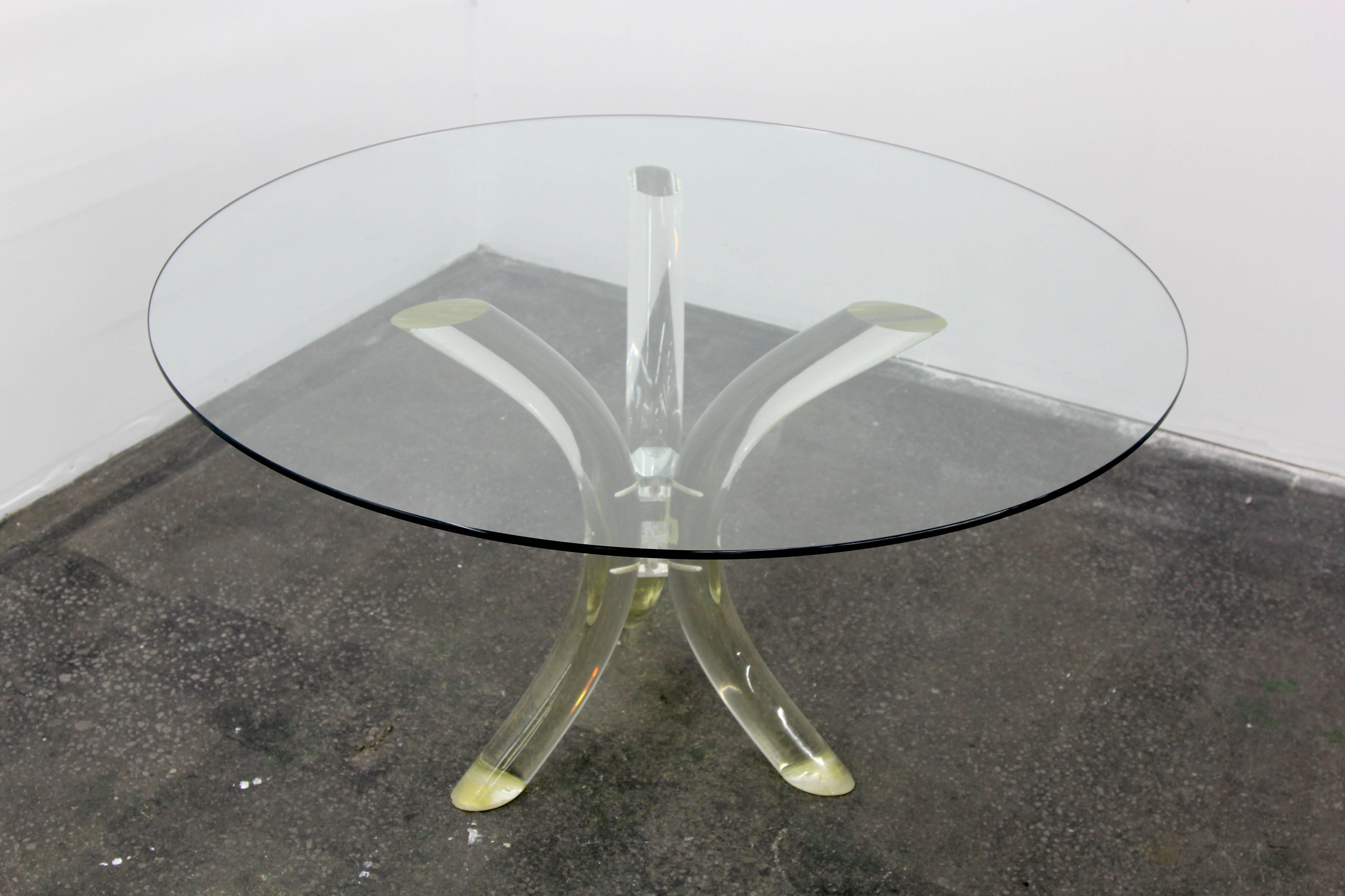 Three curved Lucite pillars make up the base of this Tusk table by Charles Hollis Jones. Joined in the center and capped by a small mirror. 50 Inch glass top can be swapped for larger or smaller piece. Beautiful mid century modern styling.