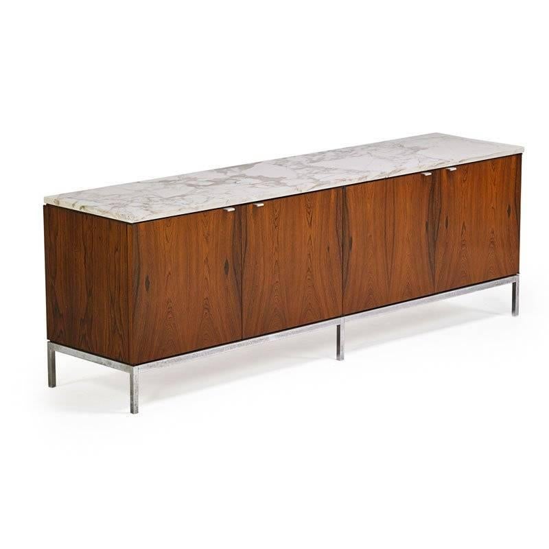Iconic Florence Knoll designed, Knoll manufactured marble-top rosewood credenza. Having four cabinet doors on chrome frame with interior shelves. Great configuration for dining room, living room, or office. Beautiful Carrara marble top, wonderful