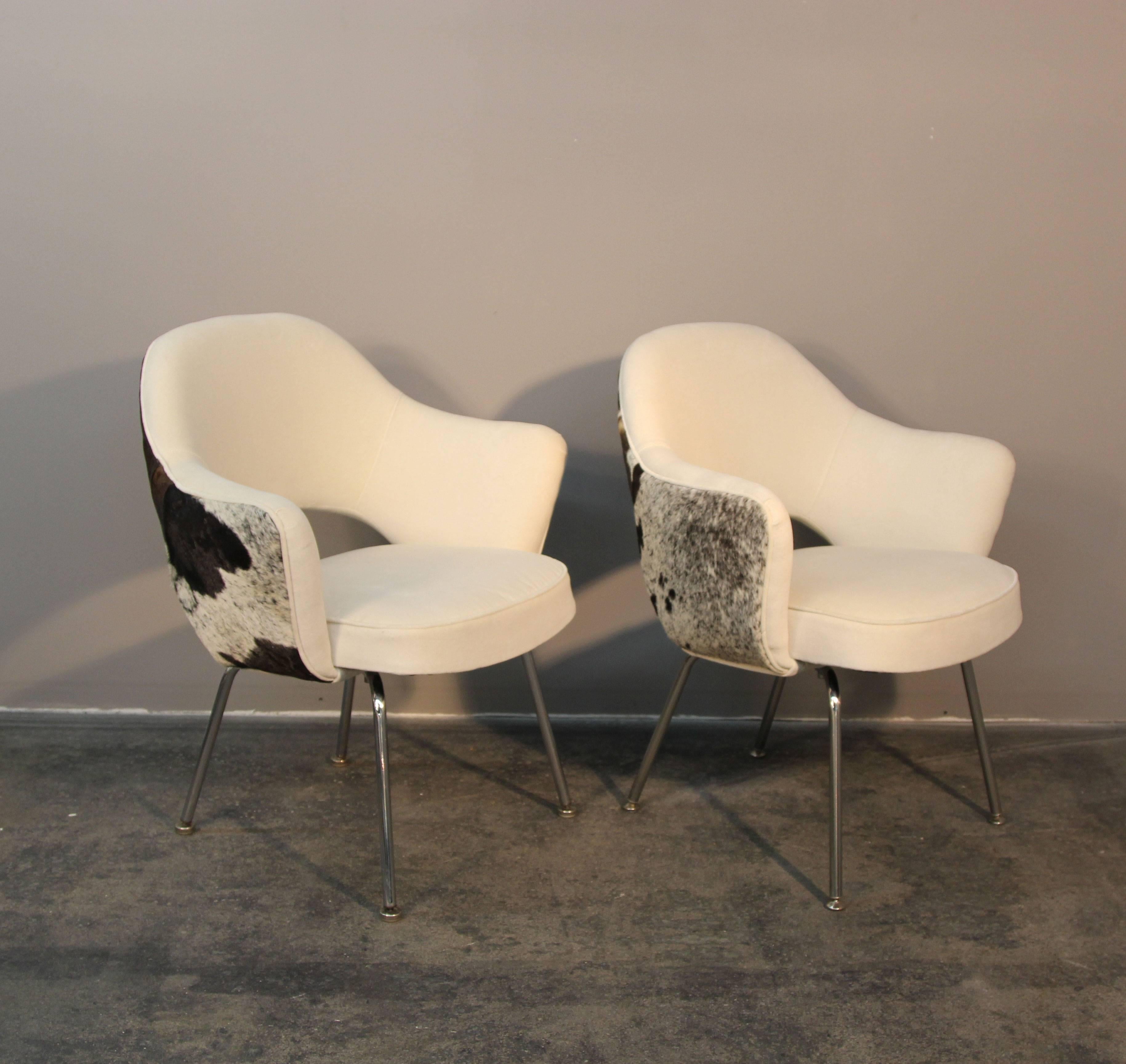 Amazing set of six newly upholstered Saarinen executive chairs. There is nothing corporate about these execs, upholstered in black and white hide backs with white velvet fronts. Amazing addition to any table.