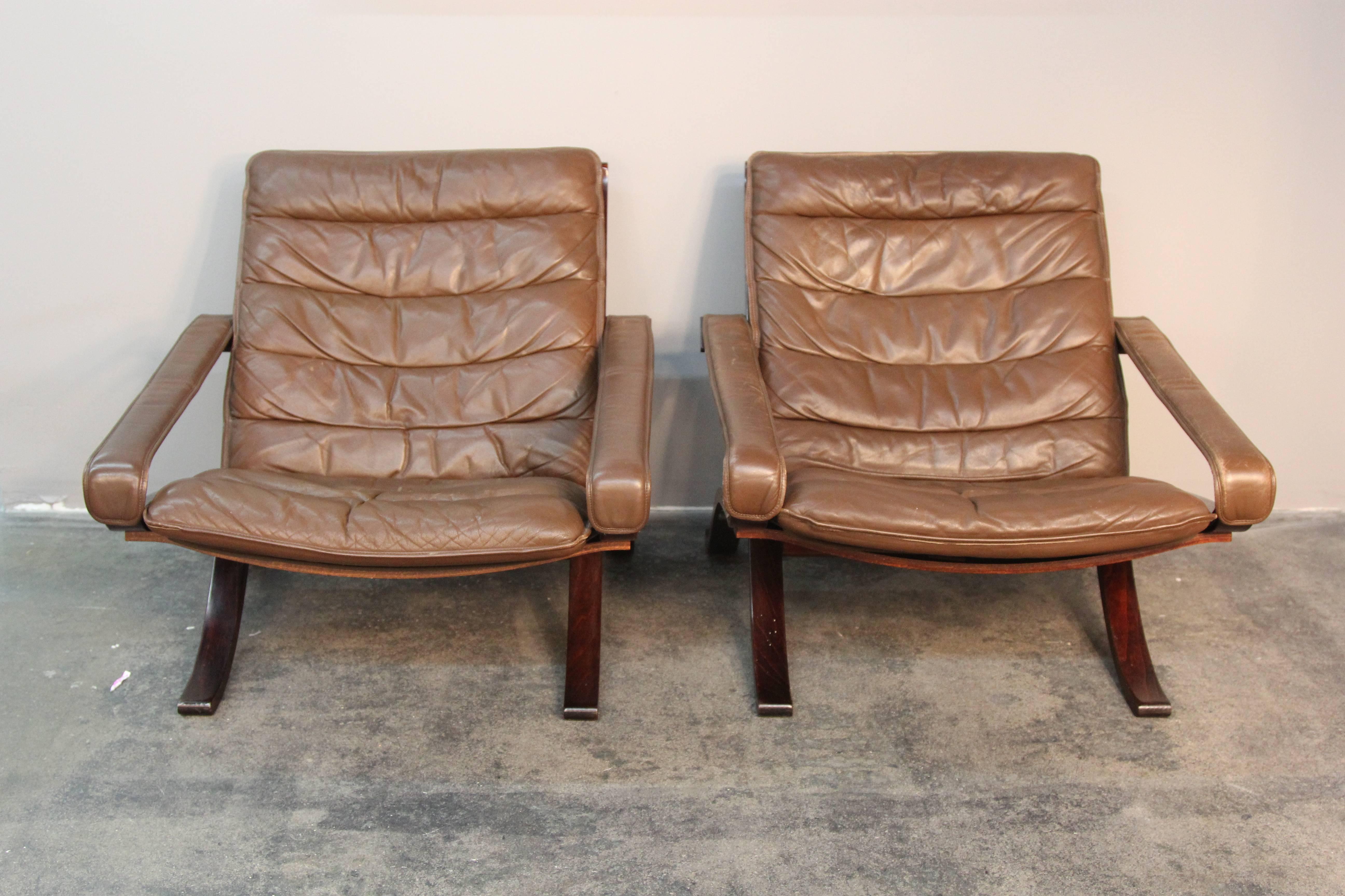 Pair of folding safari chairs by Ingmar Relling for Westnofa.  Leather upholstery and arms, rosewood frame.  Original Westnofa label.