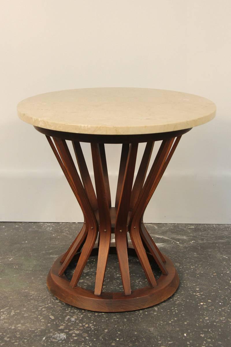 Beautiful walnut table, sheaf of wheat style by Edward Wormley. Has round travertine top, but can be replaced with glass to update and modernize. Excellent condition.