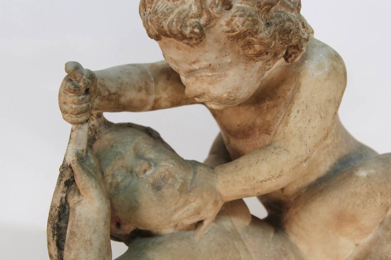 Baroque 17th Century Sculpture of Putto at Play For Sale