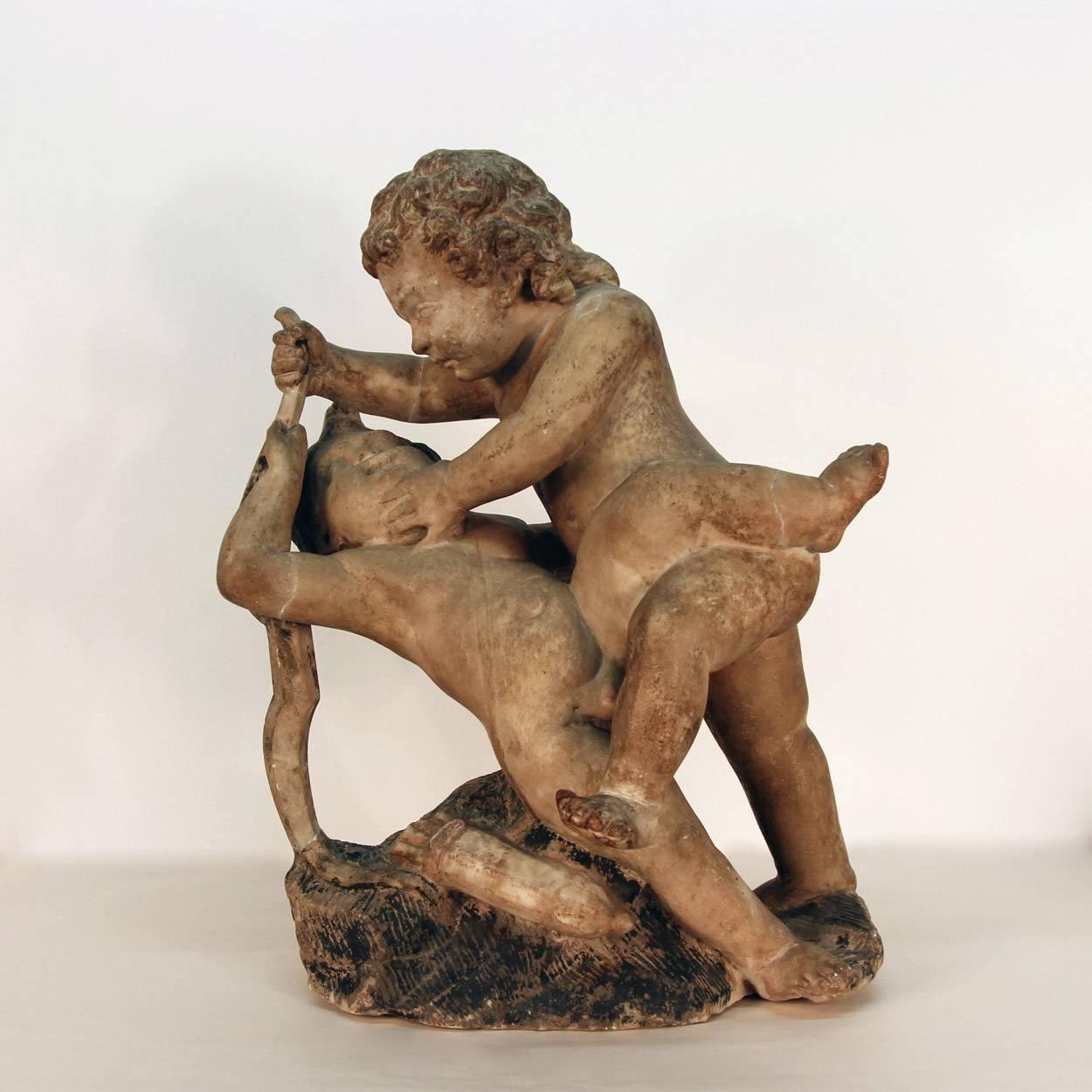 A circa 1600s sculpture of putti intertwined while at play. All hand-carved by a master artist with life like natural expressions on the cupids faces much like the examples of similar sculptures in Renaissance art.