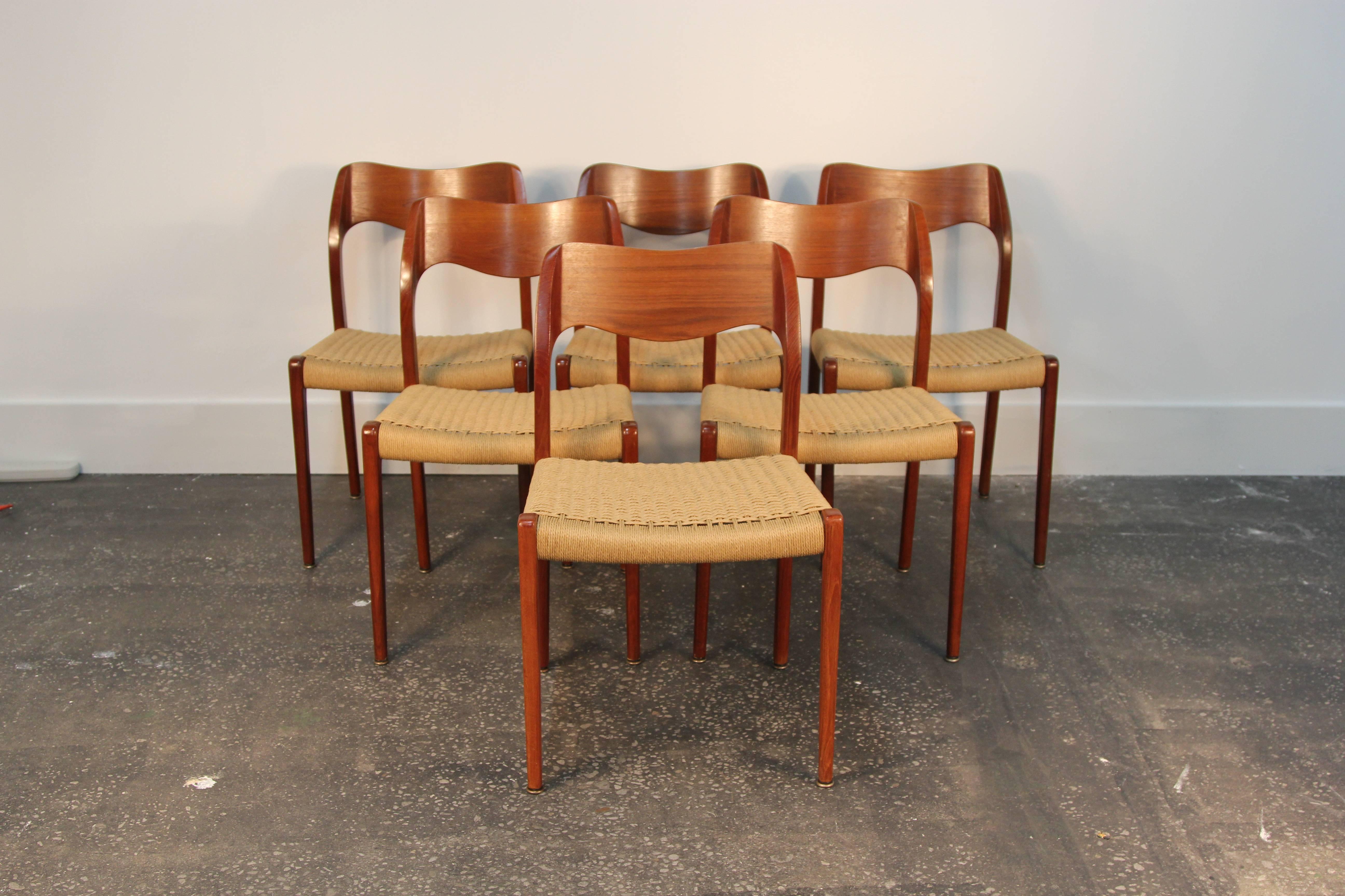 Beautiful set of 6 Model 71 teak dining chairs with danish chord seats.  Designed by Niels Otto Moller for J.L. Moller Co.  In excellent condition, paperchord seats recently redone and in perfect condition.  Gorgeous teak rich color.