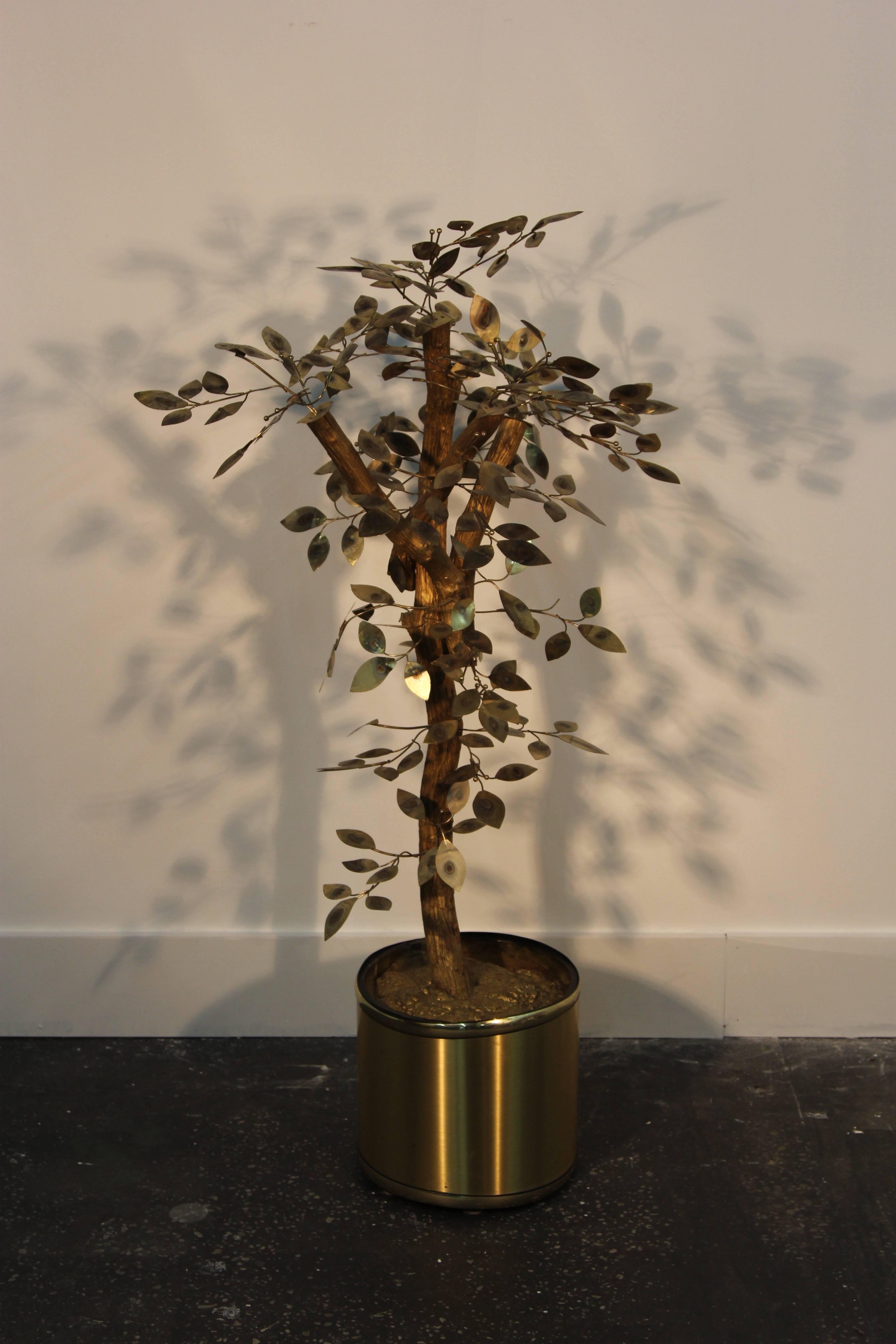 Delightful golden tone patinated brass and gilded actual tree branches coming out of a gold color plastic pot with resin interior.
