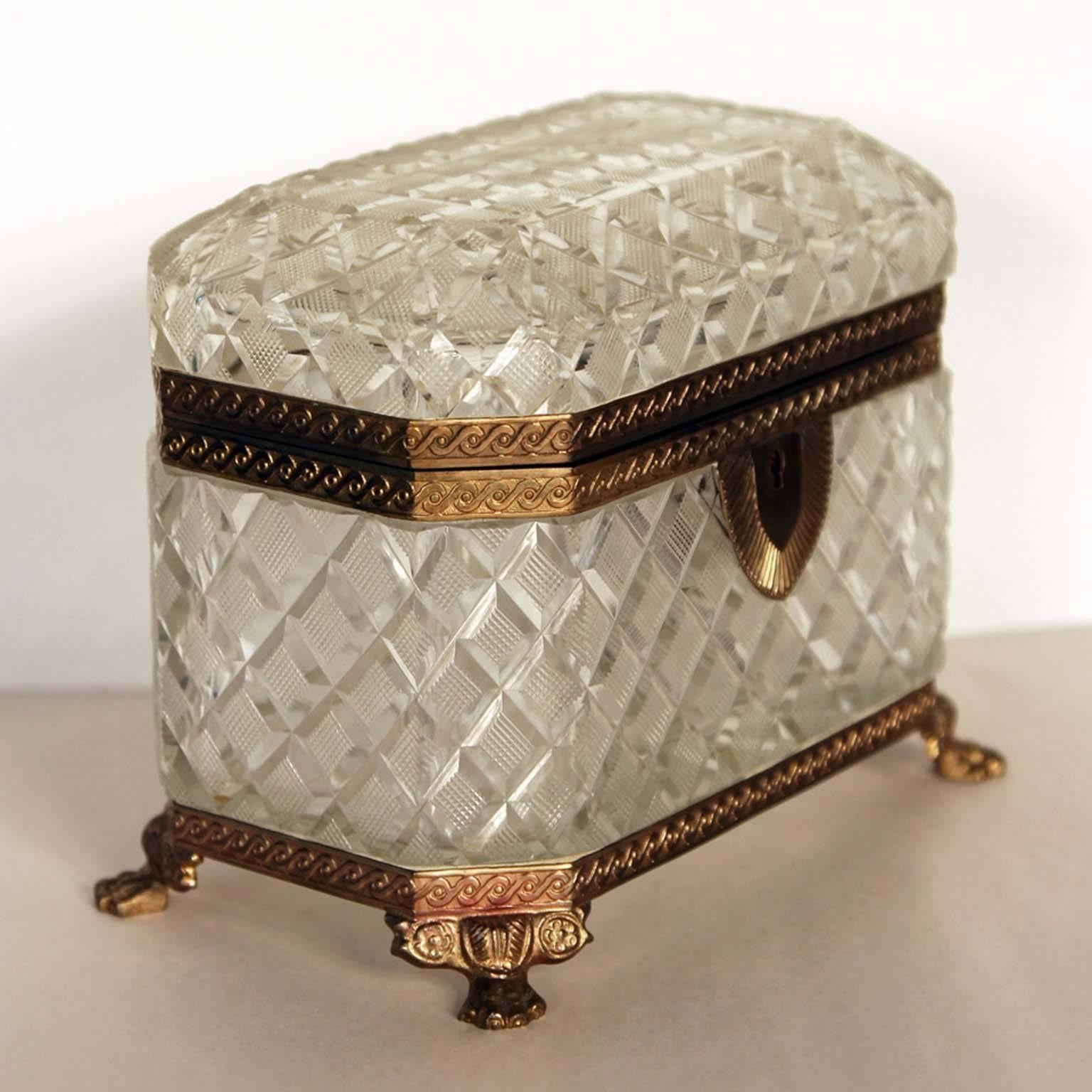 A large antique baccarat jewel box, circa 1900, French baccarat. Gilt bronze and diamond cut crystal jewel box casket having a large size. 5.5 Inches tall and 7 inches wide. Detailed animal paw feet and engine turned design work on the mounts.