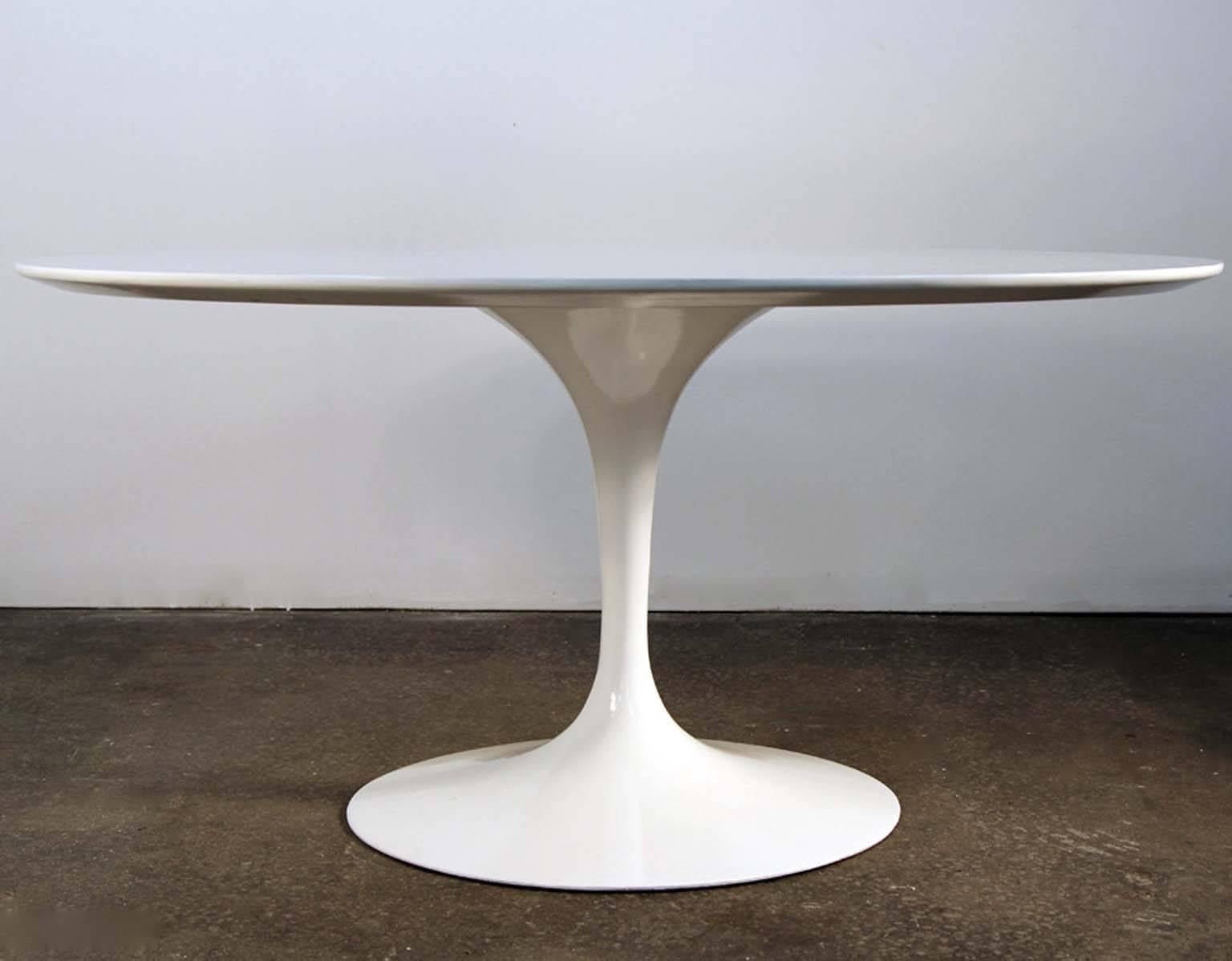 Incredible restored original Saarinen tulip table newly white lacquered. Original laminate top has been restored and lacquered in semi-gloss white, to bring new life to this original table. Knife edge top on metal base. Base powder coated and newly