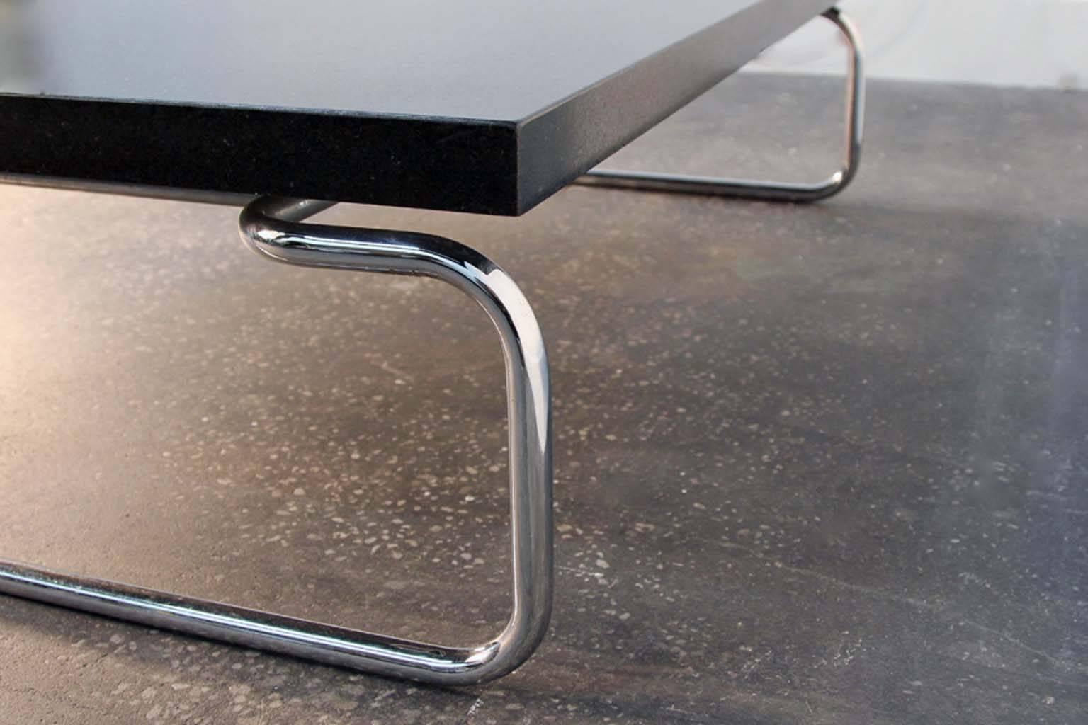 Chrome and heavy granite cocktail or coffee table by Cassina, Italy. Black thick granite top, chrome tubular base. Some light scratches or chips to the granite as shown in images.