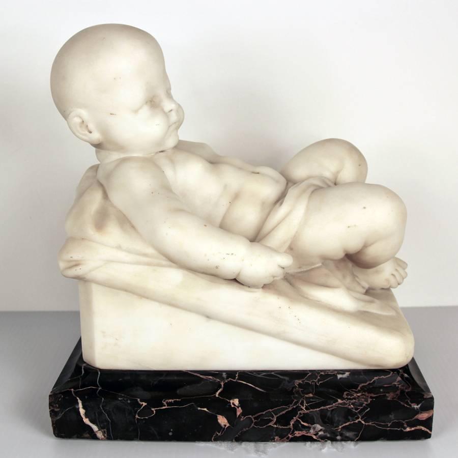 A rare carved marble sculpture by Chauncey Bradley Ives (1810-1894) Depicting a lifelike figure of a baby and the correct embodiment of an infant. With original ebony marble museum Stand where the baby sculpture has rested on since its creation by