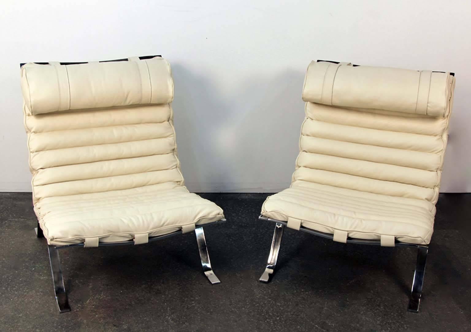 Amazing pair of Ari chairs by Arne Norell. Newly upholstered in creamy white leather. Chrome frames newly polished. Incredible rare set of incredible chairs. All newly hand done belts and buckles on back, by Italian leather craftsman.