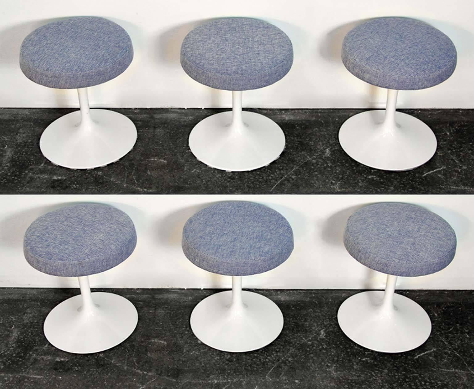 Set of six swivel tulip stools designed by Eero Saarinen in 1956 for Knoll. Newly lacquered and upholstered with original Knoll labels. These stools were featured in a Mad Men cocktail scene.