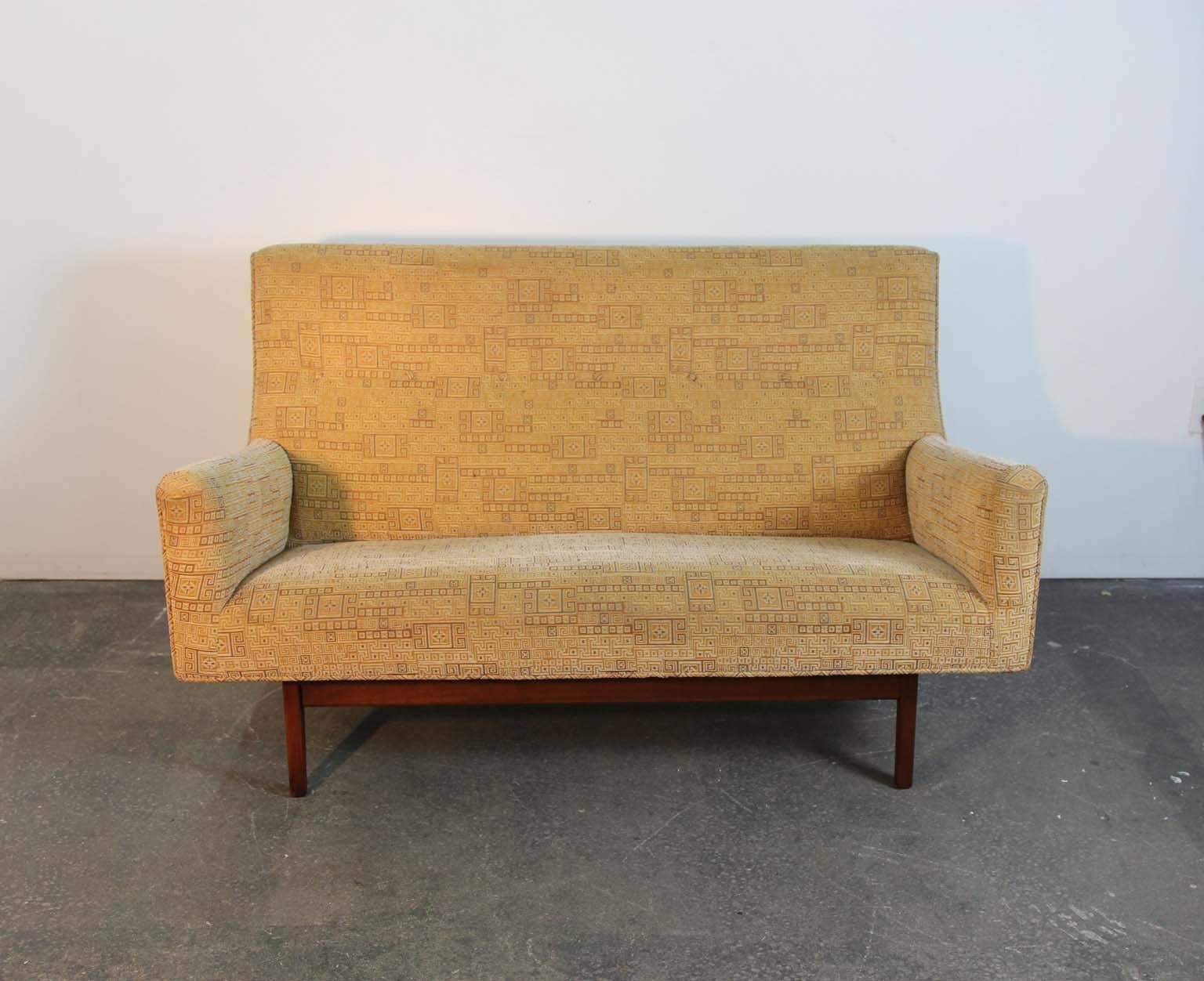 Jens Risom model U-151 two-seat settee. Original geometric fabric on a “floating” walnut base, circa 1950s. Fabric on seated surfaces show minor wear and fade from use. Walnut base is sturdy and shows signs of a re-glue to rear of one legs joinery.