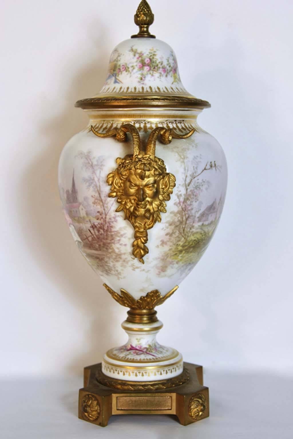 A fine antique Sevres urn, circa 1880 with gilt dore bronze ormolu mounts. Having romantic hand painted decorations on both sides with a revolving body so both sides can be viewed.