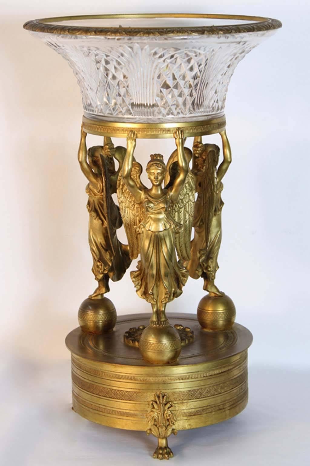 Antique French Empire baccarat and bronze crystal centerpiece attributed to Pierre Philippe Thomire. A palace size French Empire antique gilt bronze figural centerpiece with its original diamond cut Baccarat crystal bowl. Having mercury gilded