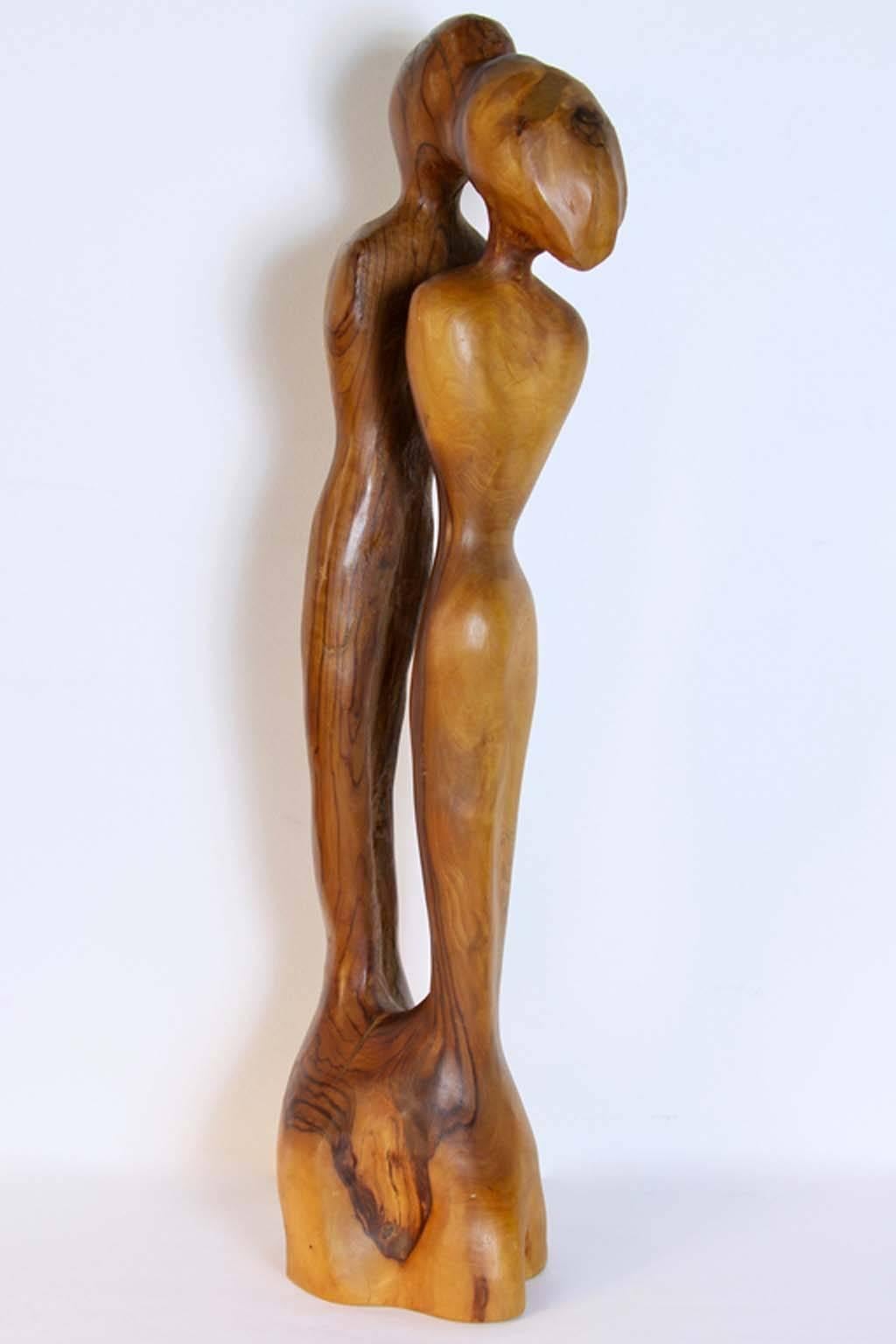 A wonderful sculpture of a couple embracing by noted Russian/ Israeli sculptor Leon Bronstein (b 1951). It is carved of olive wood with some cracks to base.