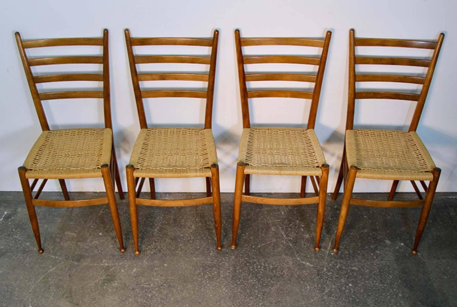 Simplicity and elegance these beautiful wood chairs with rush seats are in original vintage condition and have been freshly hand polished they are made in Italy and very much in the style of Gio Ponti.