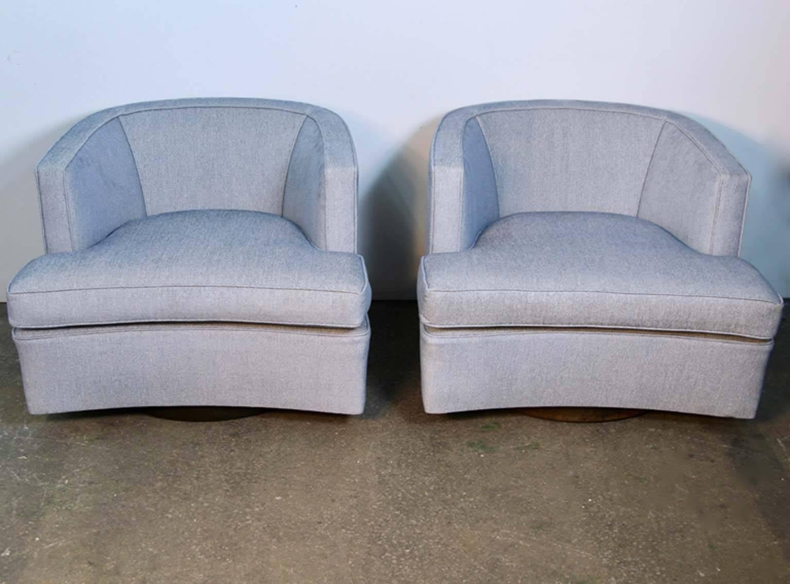 Pair of Harvey Probber chairs newly reupholstered. A fantastic design with a circular wooden base that both swivels and rolls. Amazingly comfortable and stylish. Just reupholstered.