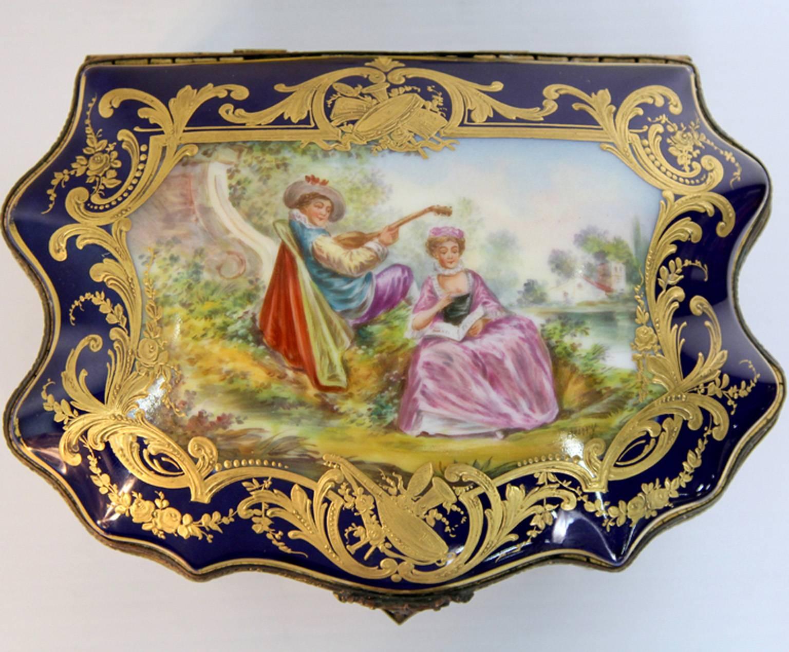 A circa 1800s French Sevres porcelain jewel box / bonbonniere in imperial cobalt blue color with raised rich gold applied decoration. In absolute immaculate conditions with all the original raised gold as well as the polychrome enamel decoration