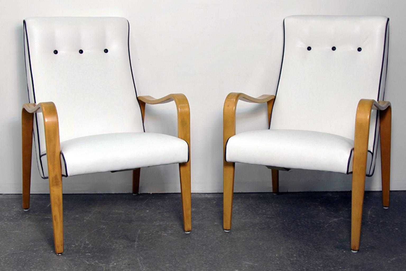Beautiful pair of Thonet bentwood armchairs. Newly upholstered in white with contrast leather piping. Original tags, excellent mid-century style.